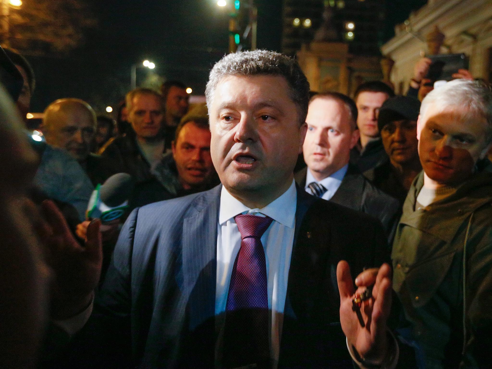 Ukrainian lawmaker Petro Poroshenko speaks with members and supporters of the 'Right sector' political party during their rally near the Ukrainian Parliament building in Kiev, Ukraine