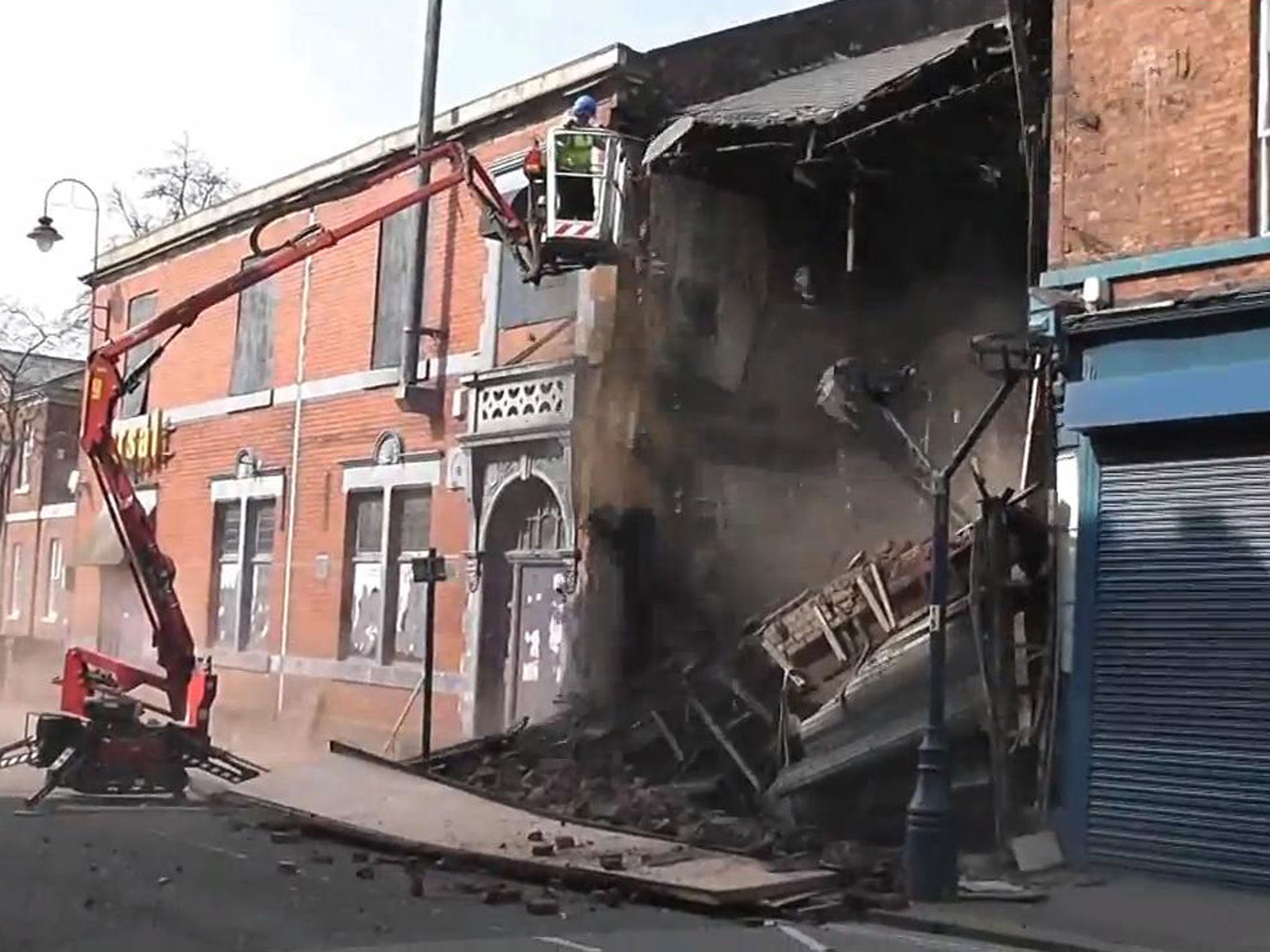 An engineer was left staring at a house-shaped hole after managing to demolish an entire building by dislodging a few bricks from the exterior wall