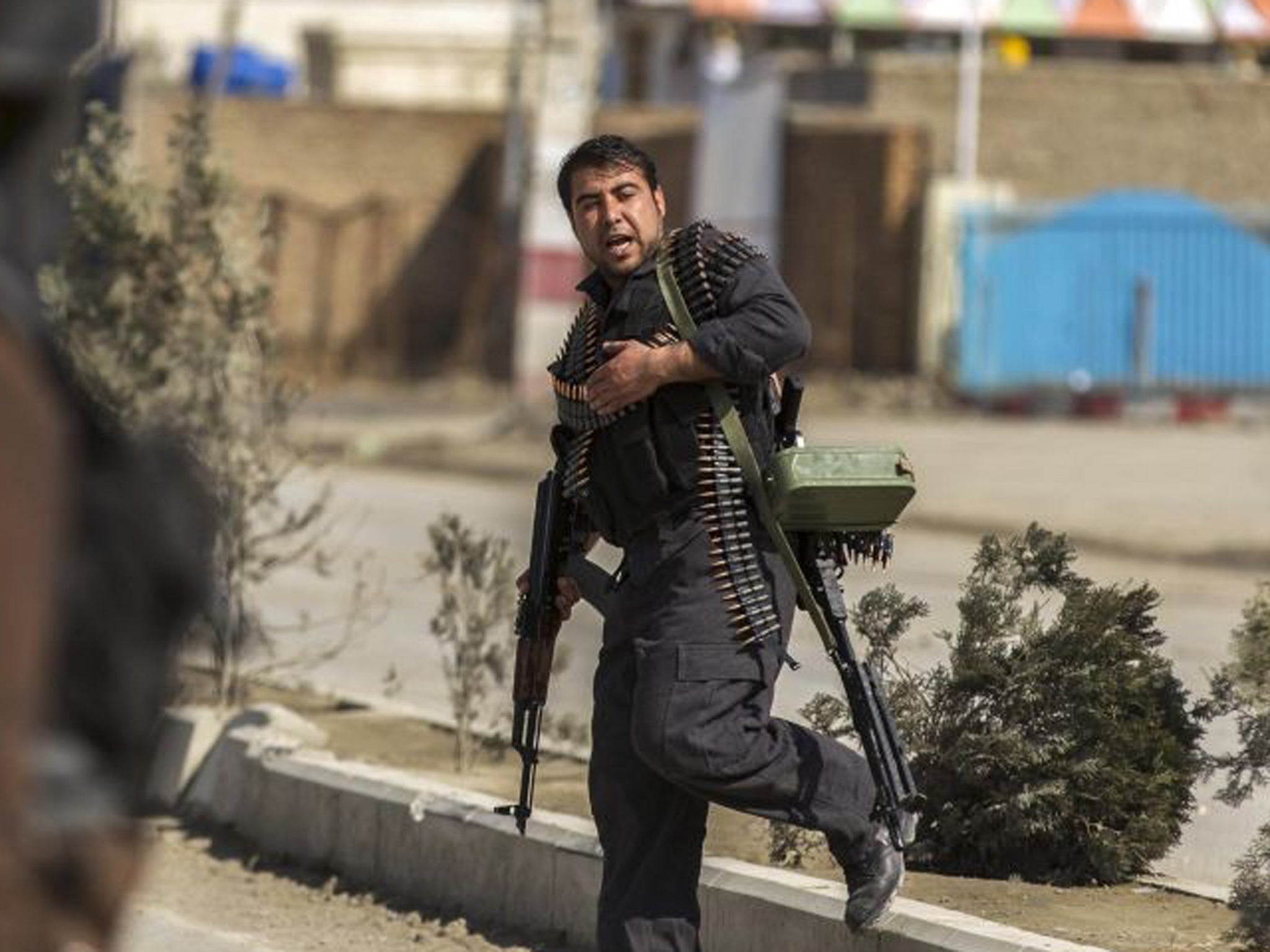 A policeman arrives at the Independent Election Commission office during the attack by insurgents