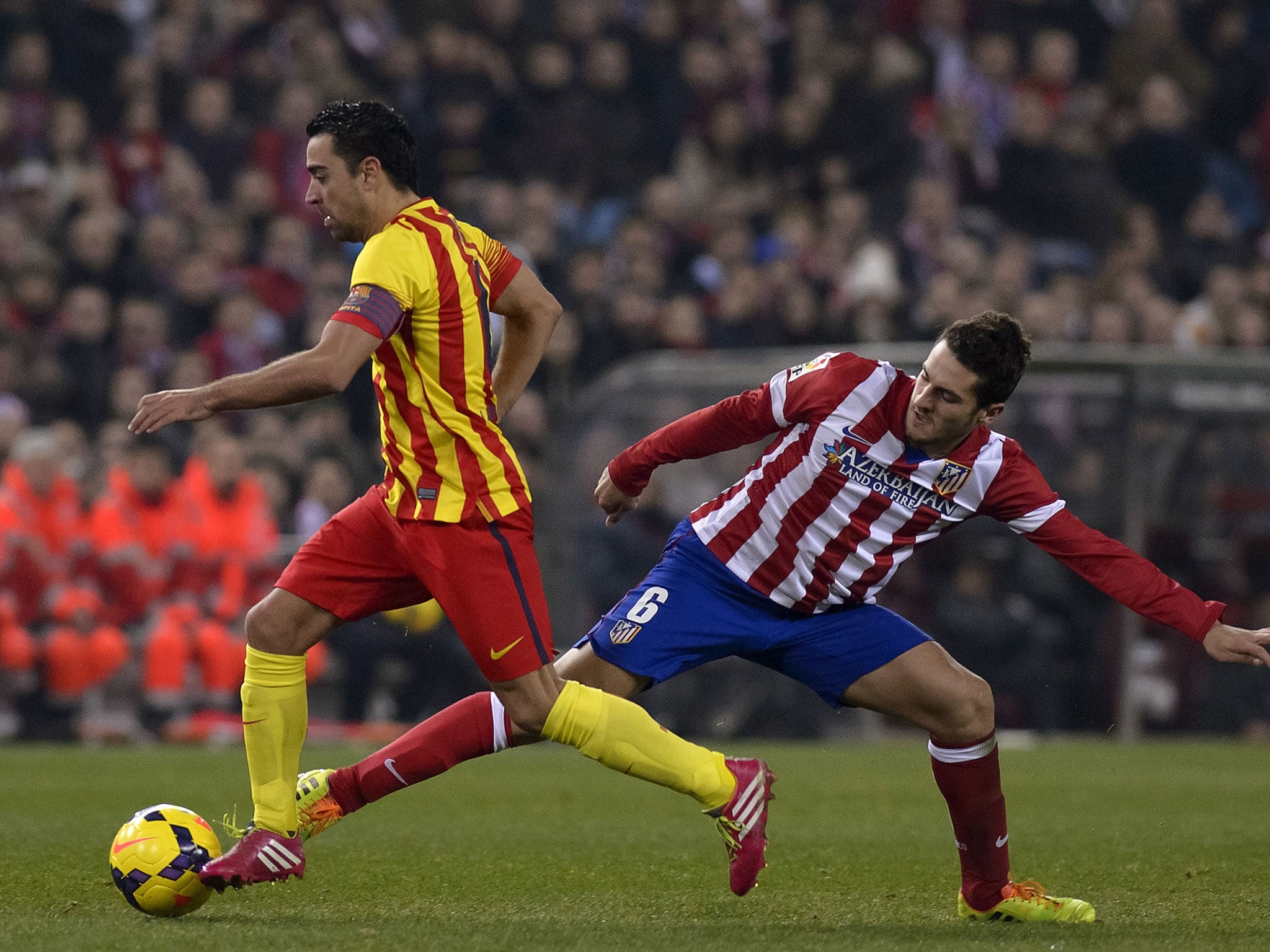 Xavi (left) and Koke vie for the ball during Barcelona's 0-0 La Liga draw at Atletico Madrid in January