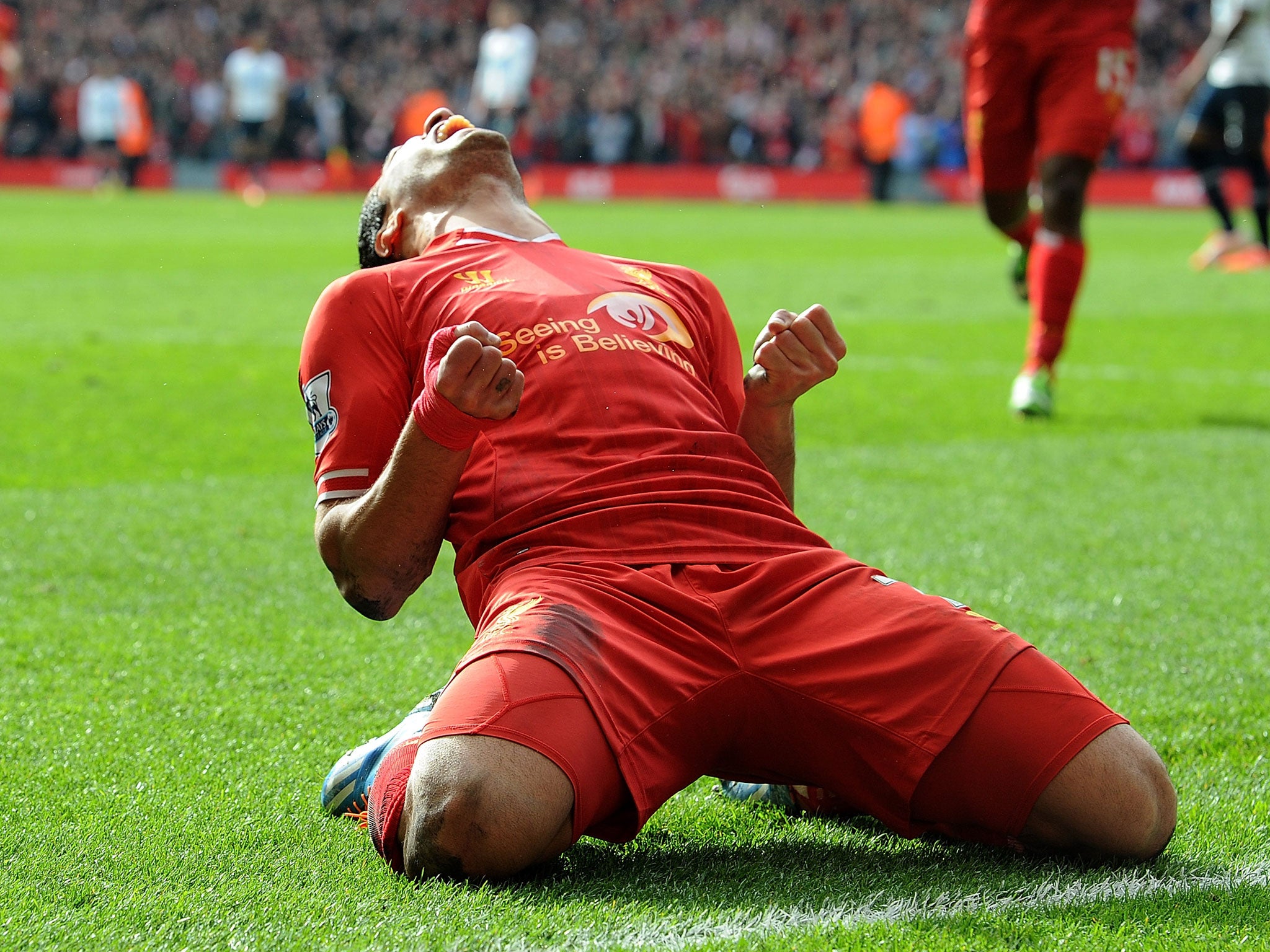 Luis Suarez celebrates a goal against Tottenham