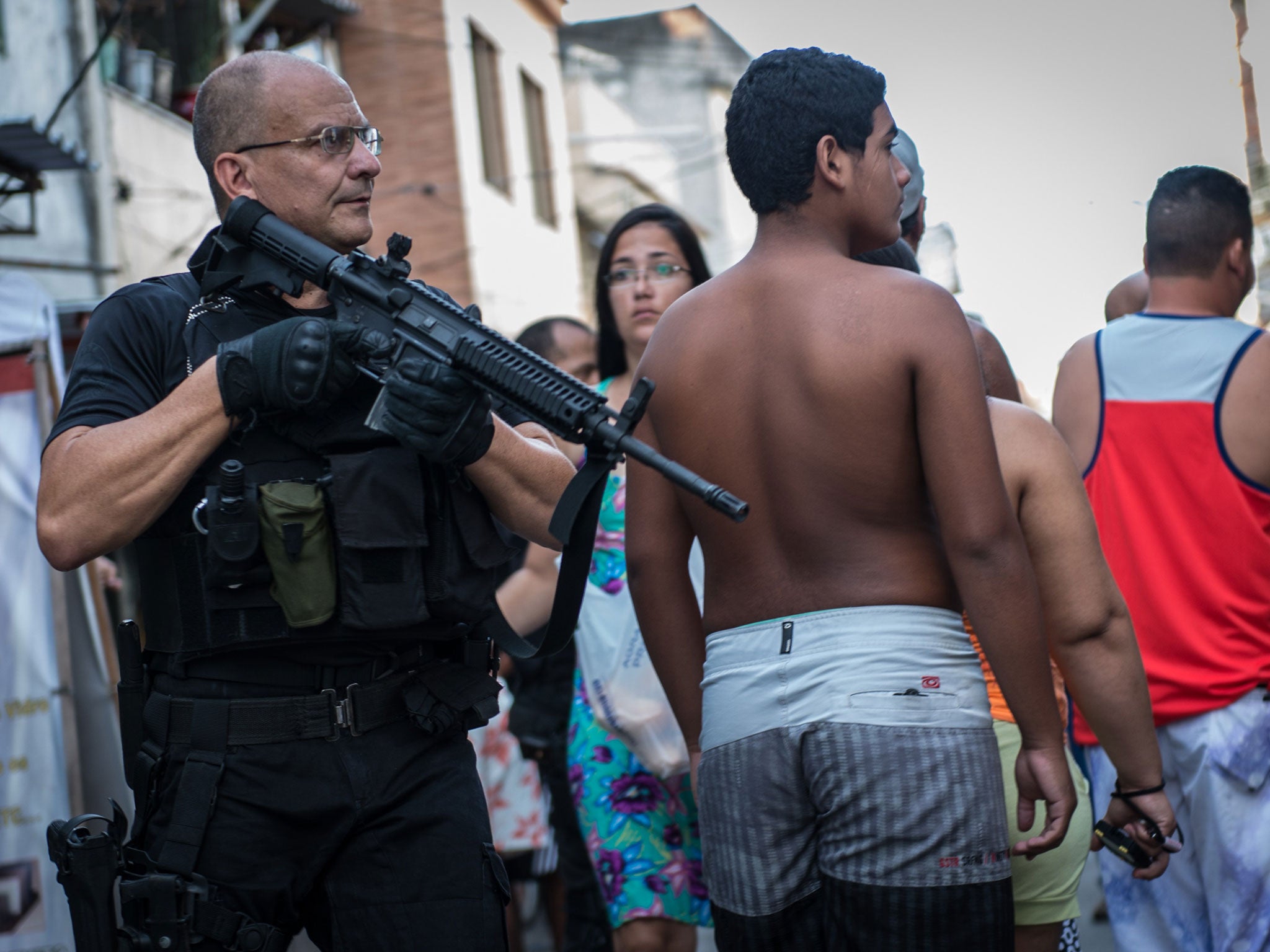 Armed police patrol the streets of the favela