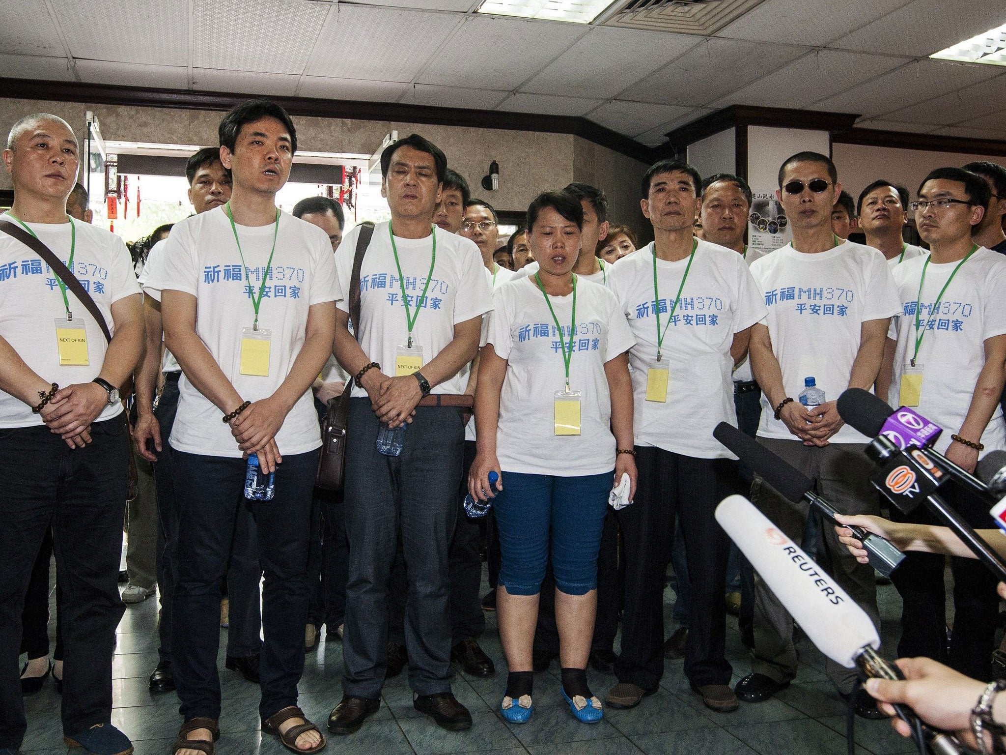 Chinese relatives of the passengers on missing Malaysian Airlines flight MH370 speak to media after holding special prayers at a Buddhist Temple in Petaling Jaya, Malaysia