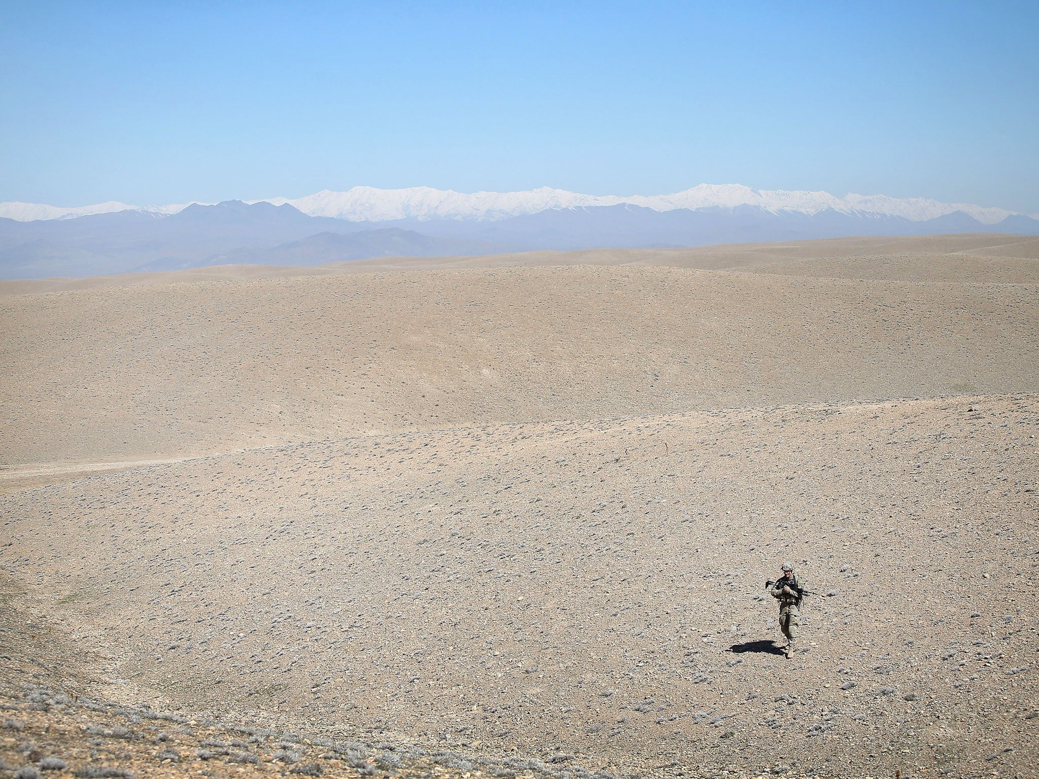 A US Army soldier is seen in the barren foothills near Pul-e Alam, Afghanistan