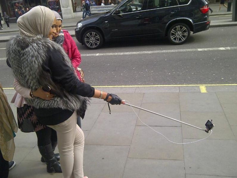 Walking a dog? Prospecting with a metal detector? No, photographing self from pavement-eye-view!