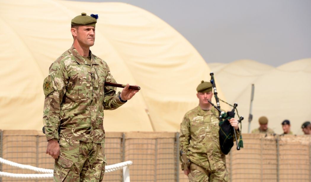 British army soldiers look on during a ceremony to disband the British millitary headquarters at Camp Bastion in Afghanistan's Helmand province on April 1, 2014.