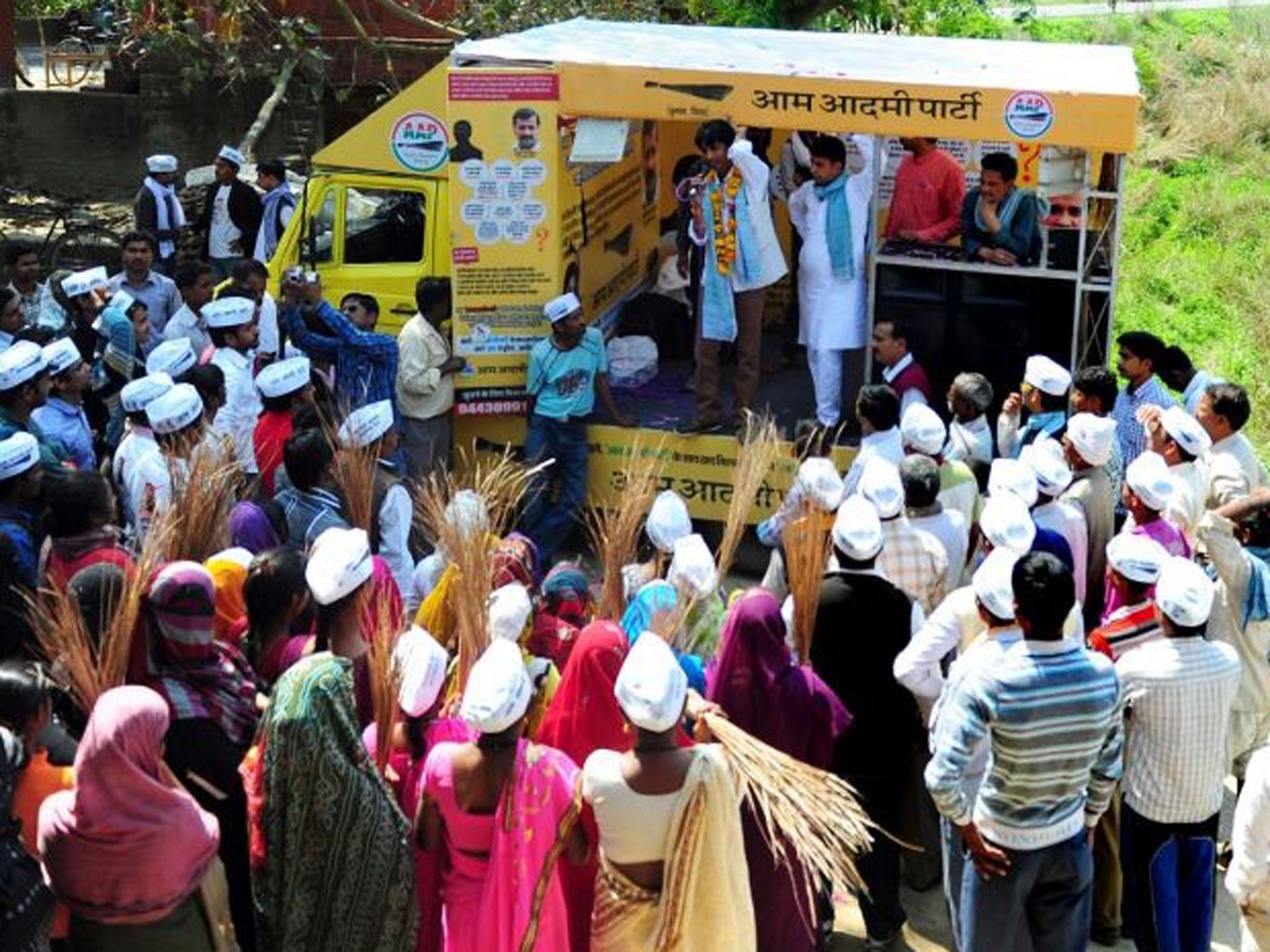 Indian villagers listen as they are addressed by election candidate Kumar Vishwas