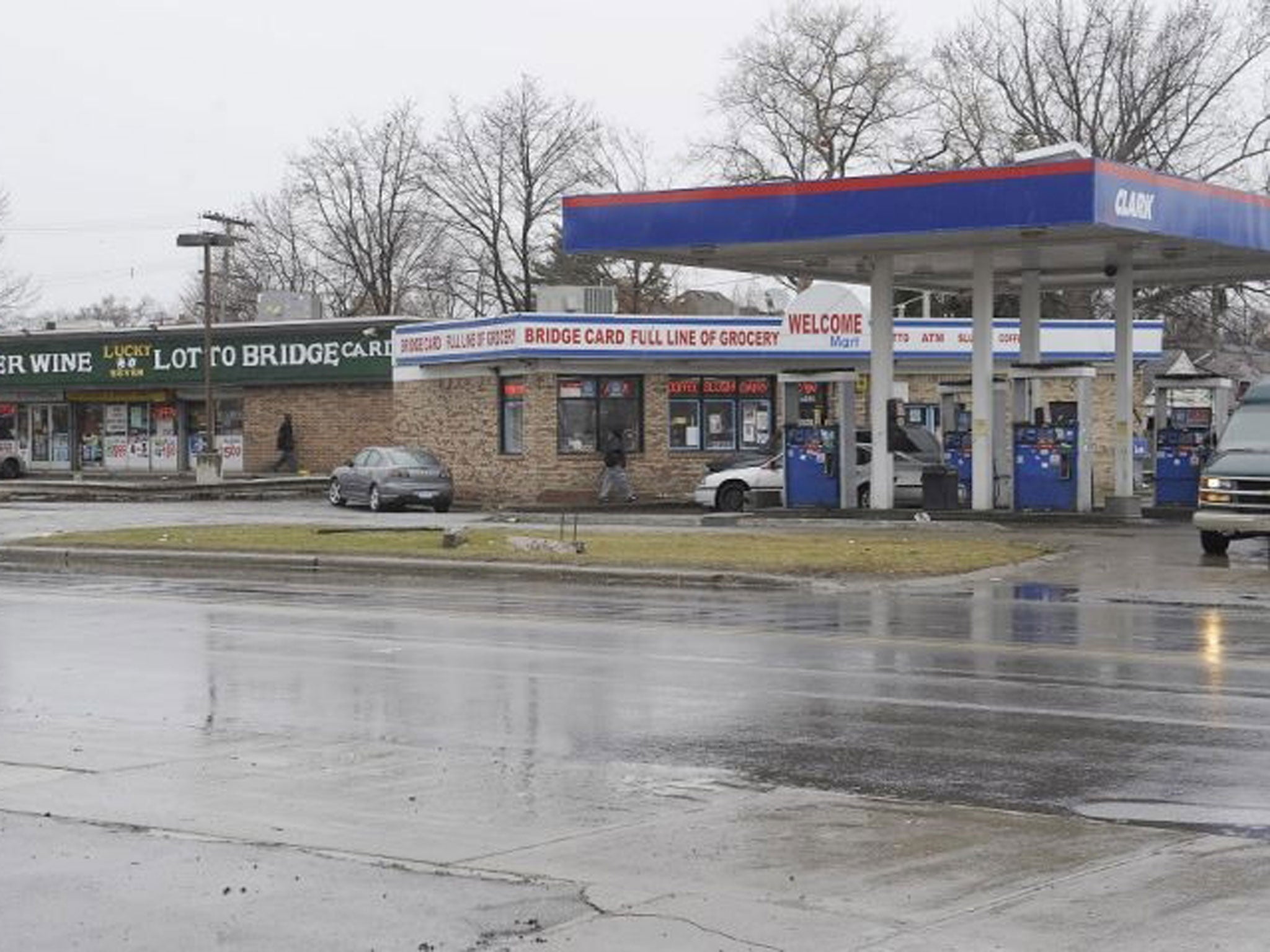Cars enter local business at the scene of an attack on Wednesday in Detroit.