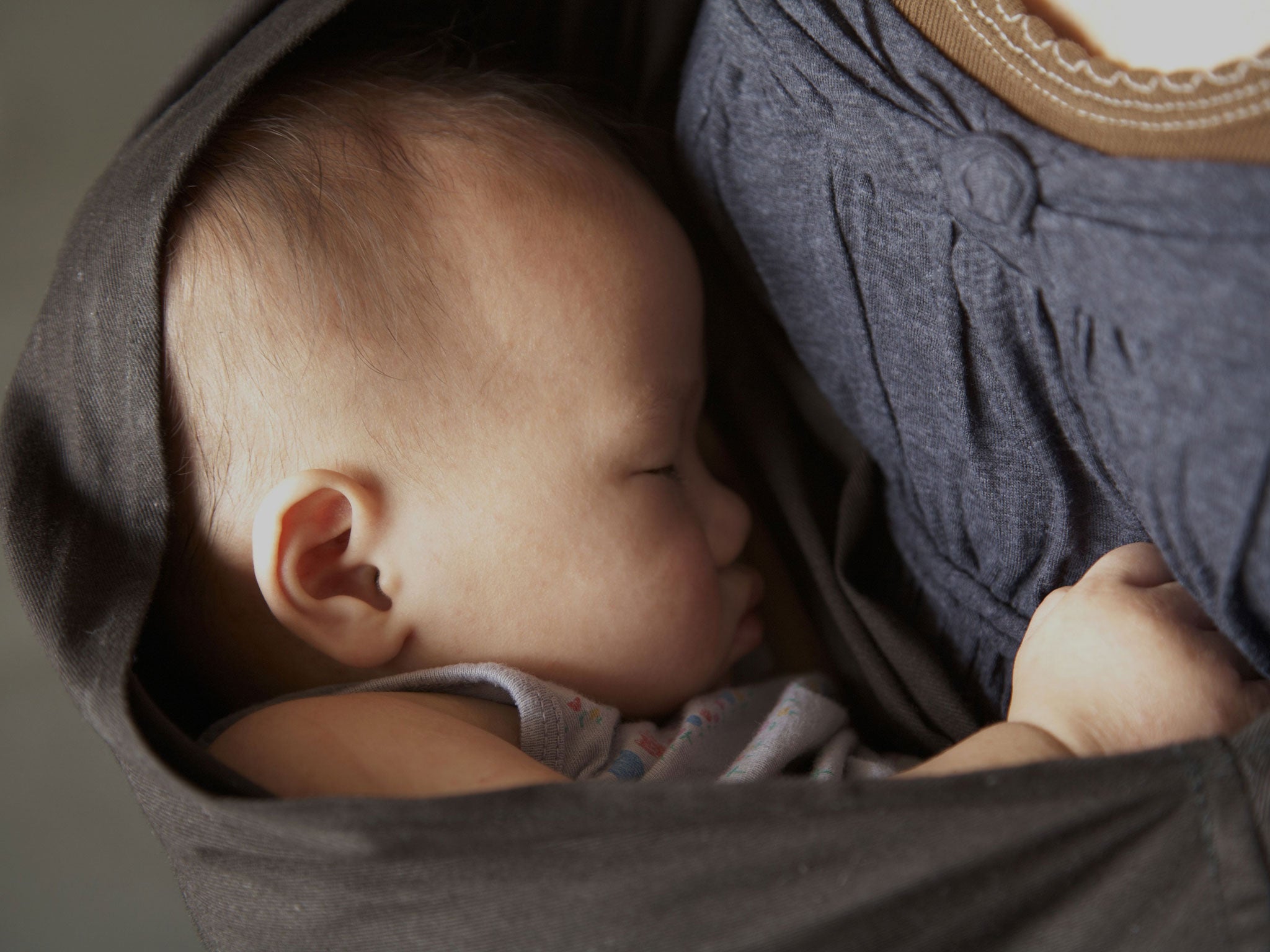 A baby, unrelated to the Eric Matthews' death, being held in a sling.