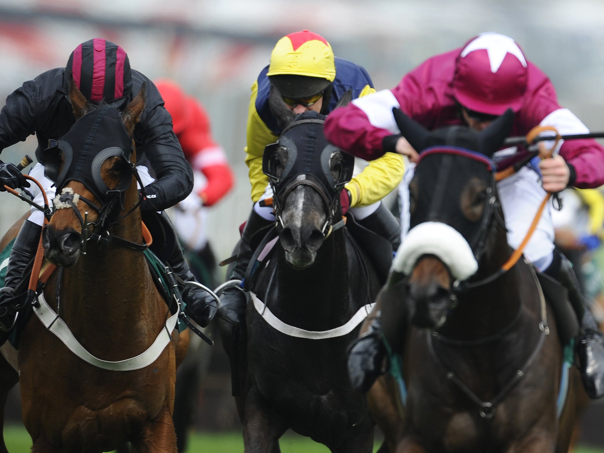 Paul Carberry riding Guitar Pete (C) clear the last to win The IJF 50th Anniversary Juvenile Hurdle at Aintree racecourse