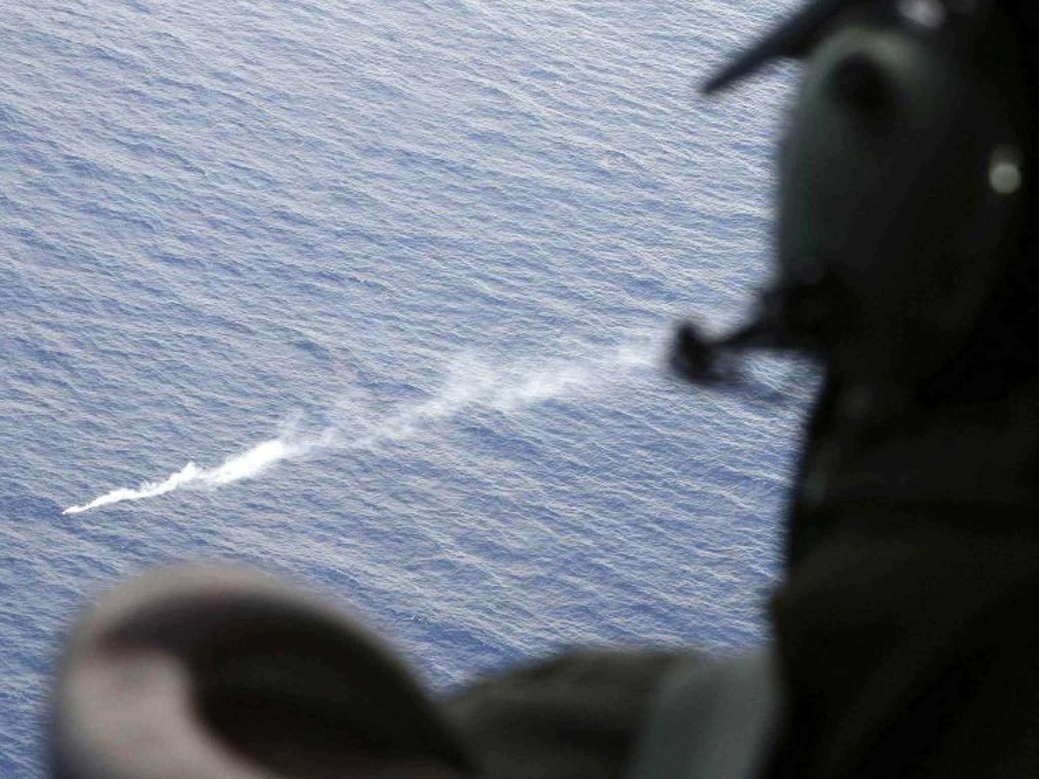 A Royal New Zealand Air Force jet investigates a sighting of debris