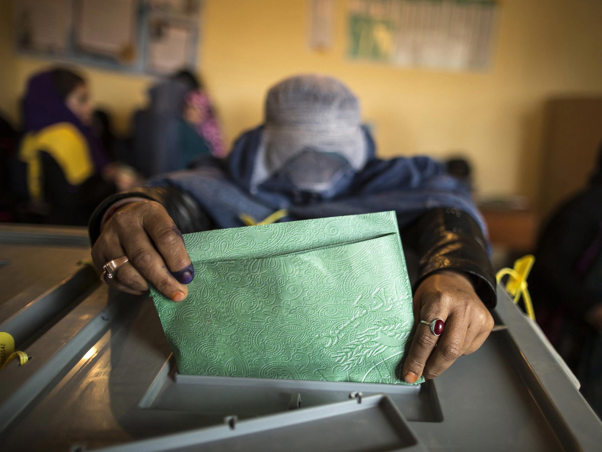 An Afghan woman casts her ballot at a polling station in Mazar-i- sharif