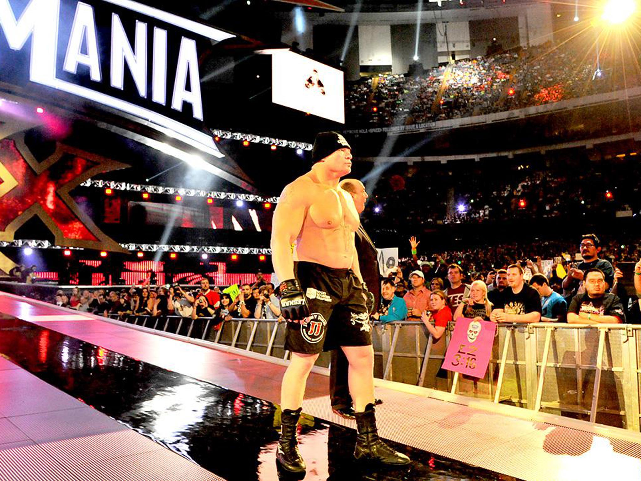 Brock Lesnar heads to the ring for his showdown with The Undertaker, accompanied by Paul Heyman