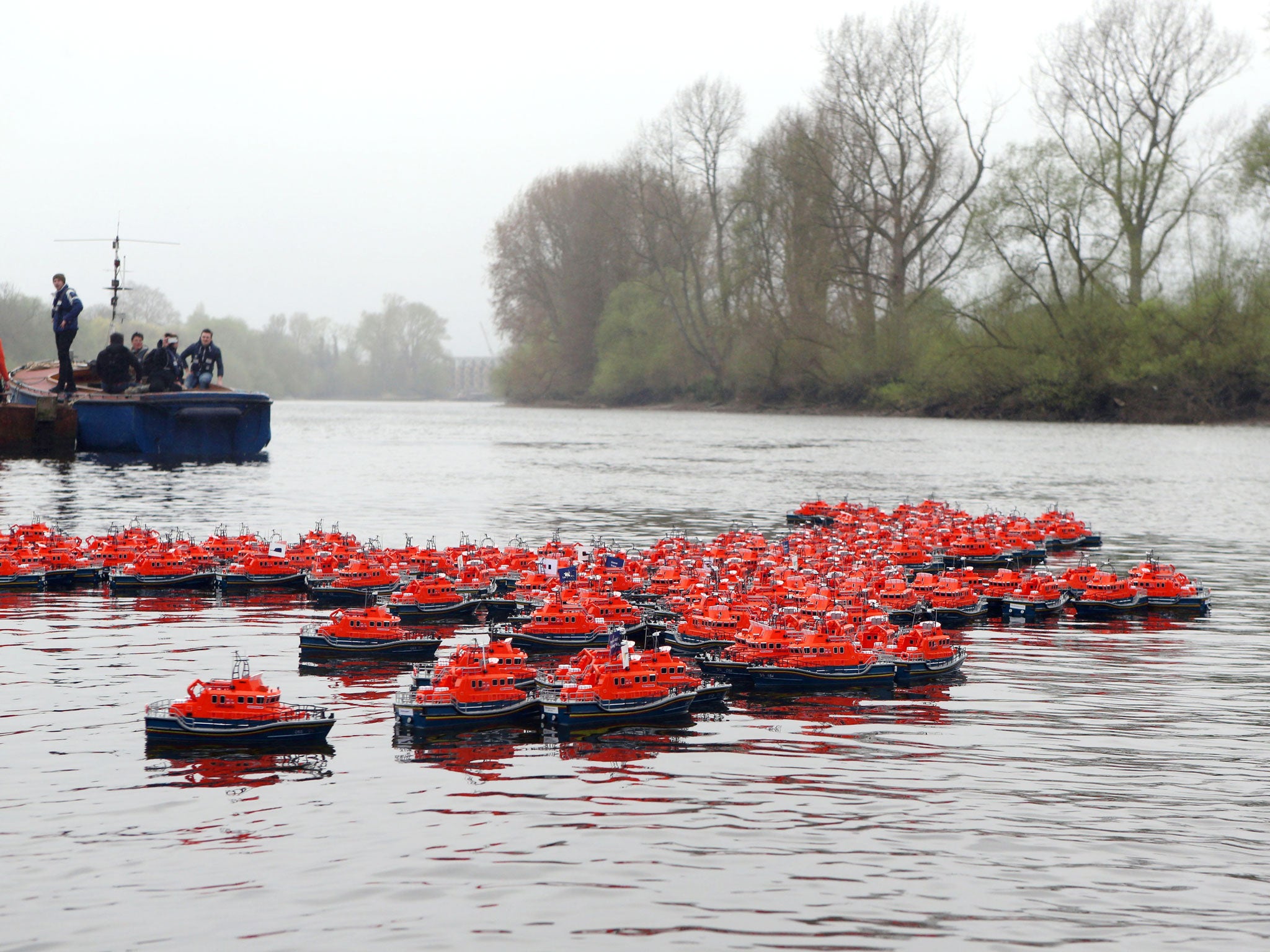 250 model lifeboats take to the River Thames in the RNLI's Alternative Boat Race to raise awareness and funds for the Royal National Lifeboat Institution (RNLI)