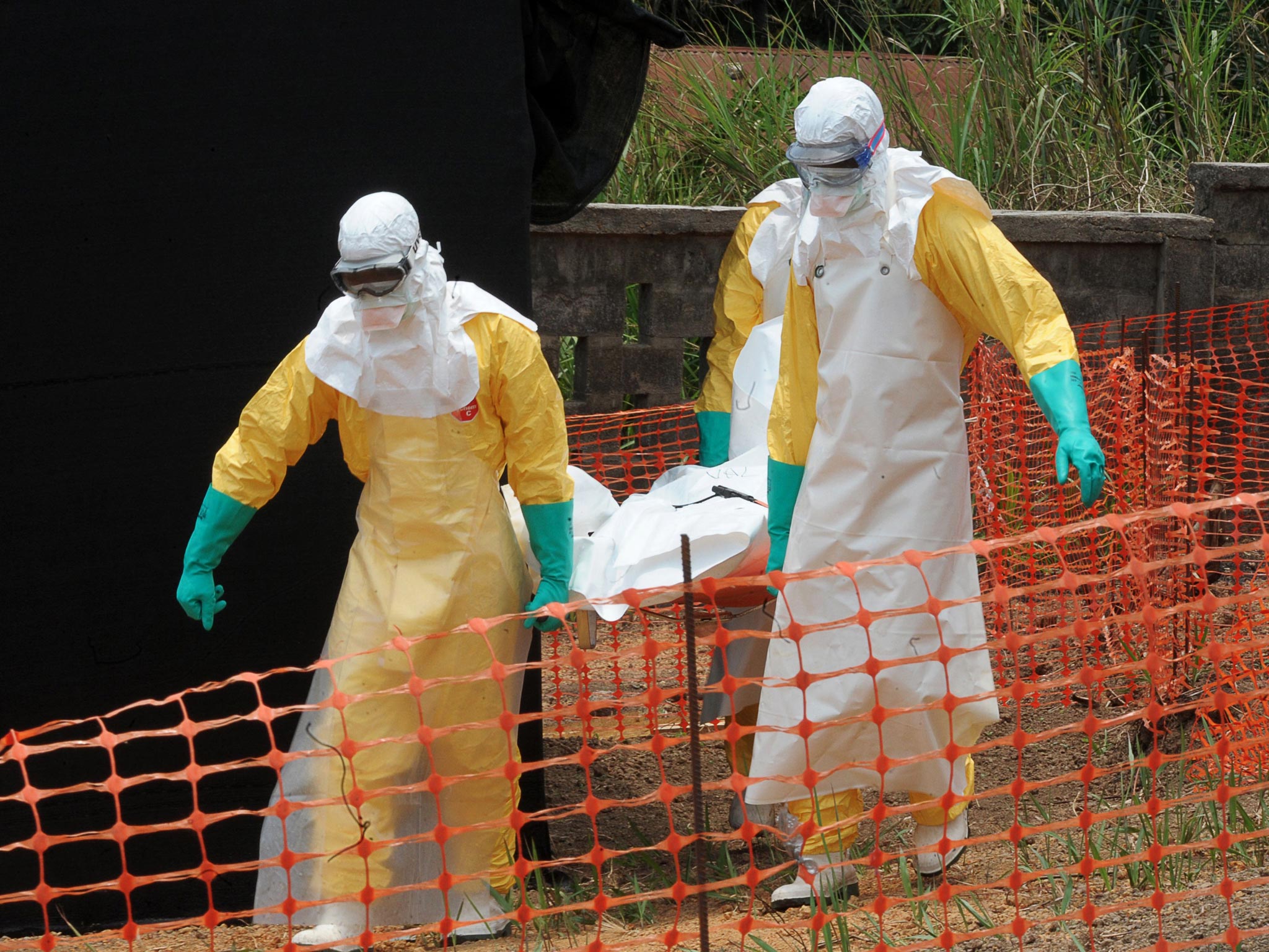 Staff of the 'Doctors without Borders' ('Medecin sans frontieres') carry the body of a person killed by viral haemorrhagic fever