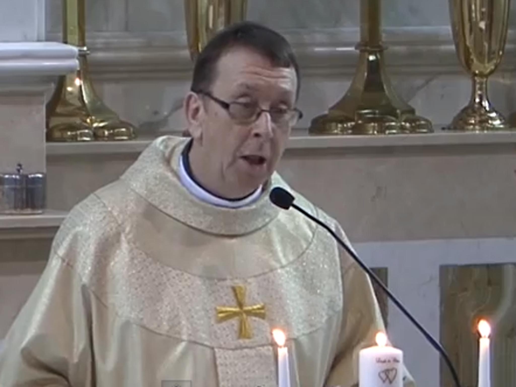 Father Ray Kelly takes to the mic and serenades the newly wed couple