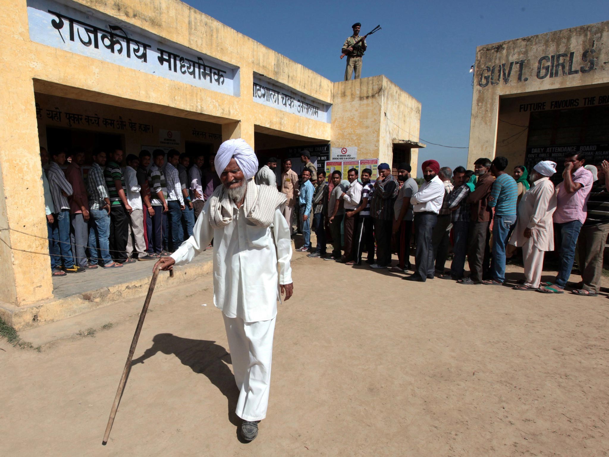 A man leaves a polling station at a village in Jammu and Kashmir state