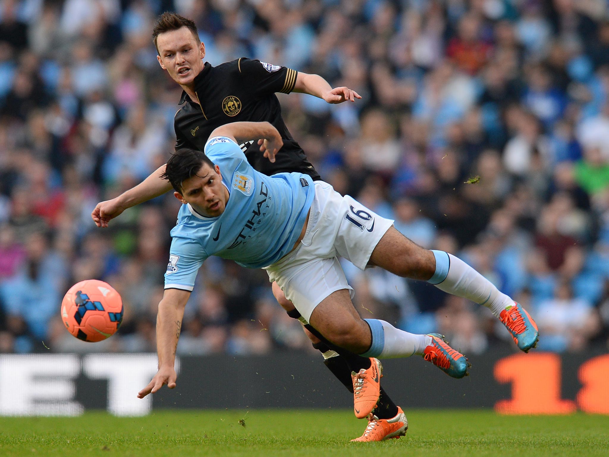 Josh McEachran tackles Manchester City’s Sergio Aguero in Wigan’s shock FA Cup quarterfinal victory