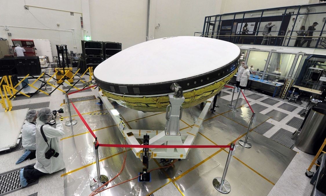 Journalists dressed in special suits are briefed inside the Clean Room at Nasa's Jet Propulsion Laboratory in Pasadena, California on the agency's Low Density Supersonic Decelerator (LDSD) project on April 9, 2014.