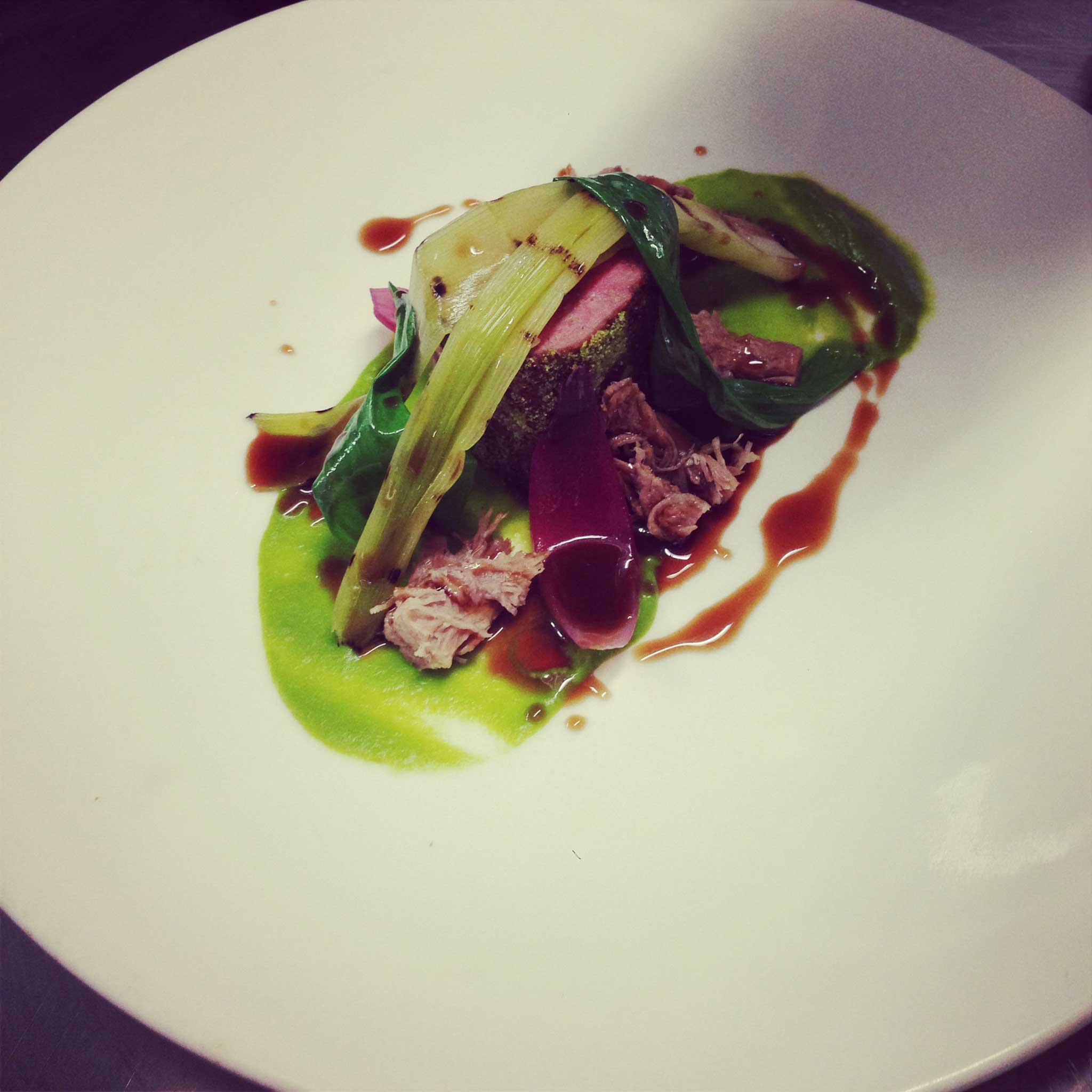 Herb-crumbed roast loin of lamb, confit belly, leek and red onion