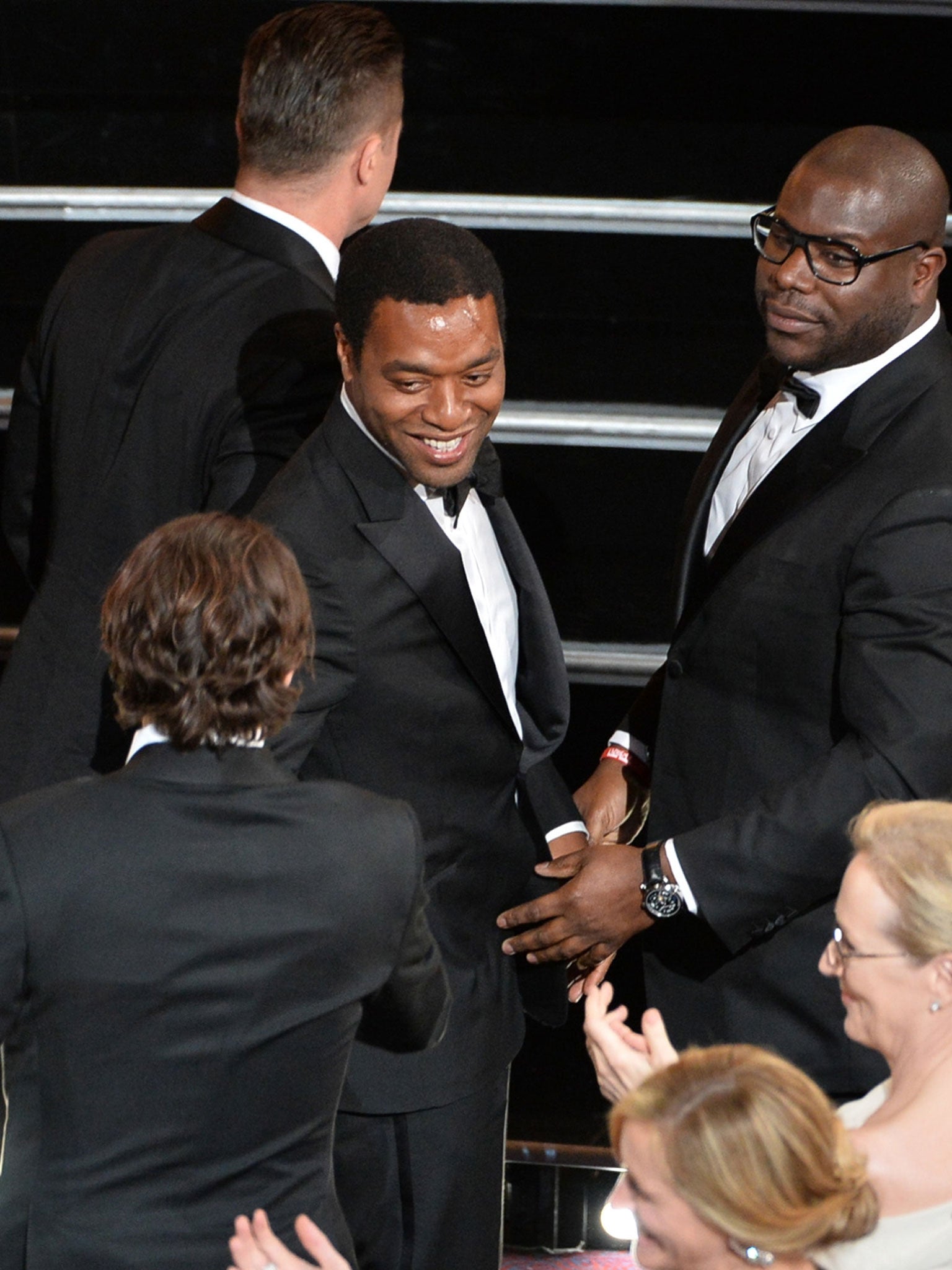 Brad Pitt, Chiwetel Ejiofor and director Steve McQueen celebrate the Best Picture award for '12 Years A Slave' at the Oscars.