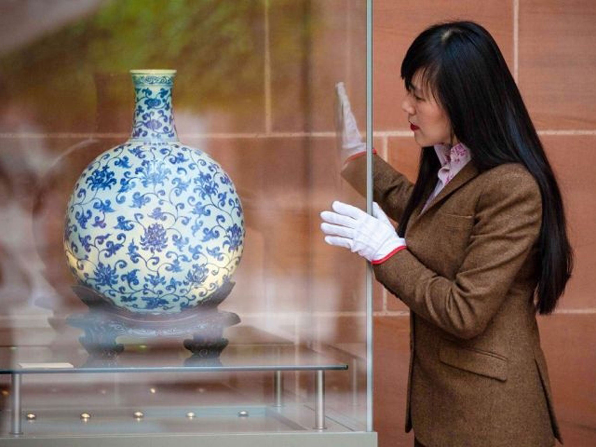 Exhibition curator Yupin Chung viewing a newly-installed Ming vase at the Burrell Collection in Glasgow.