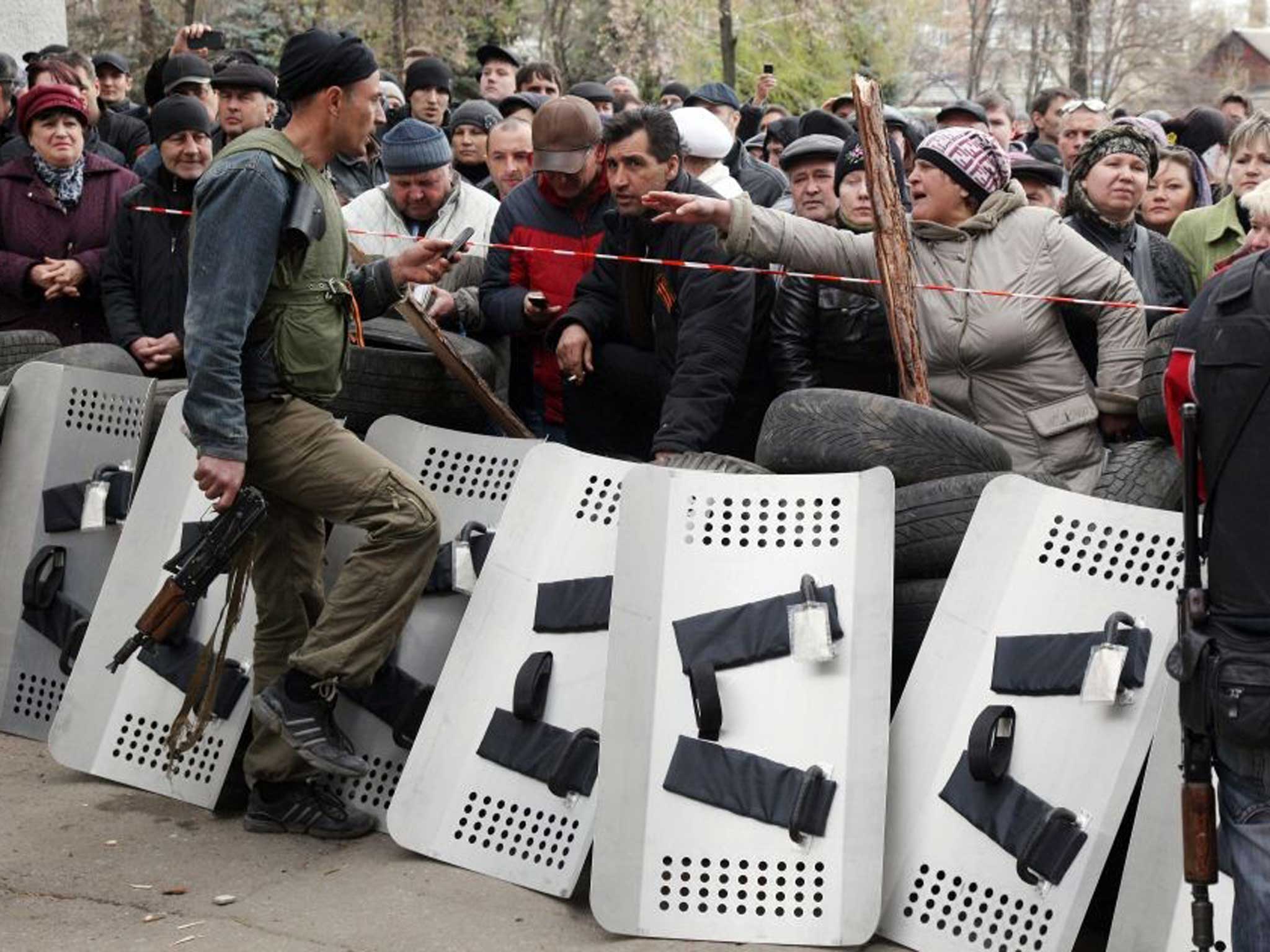 Taken control: Pro-Russian activists guard the police station they seized in Slavyansk
