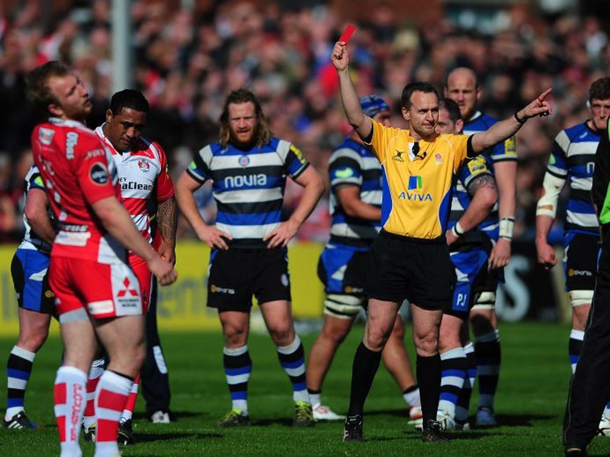 Referee Tim Wigglesworth shows the red card