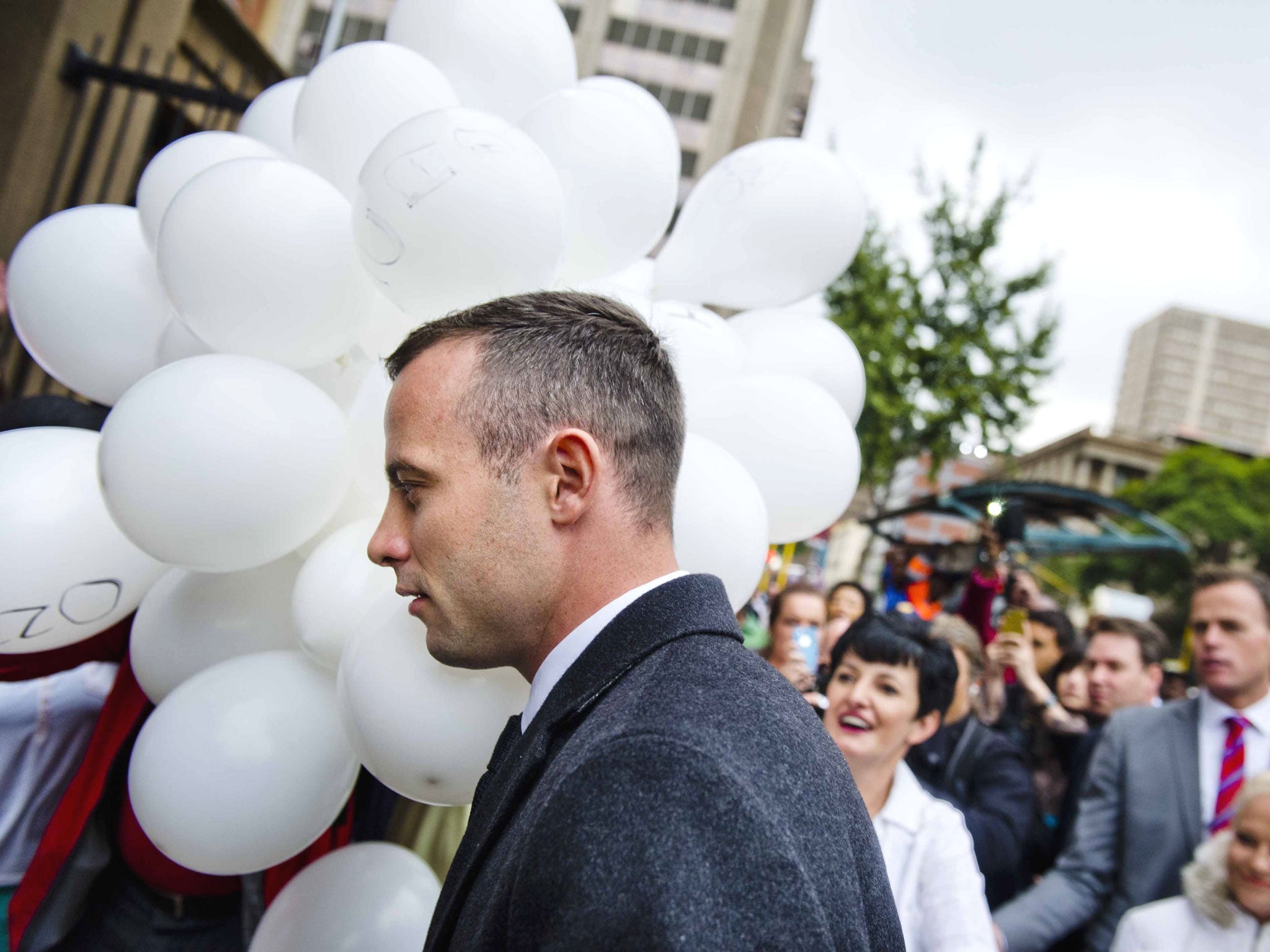 Oscar Pistorius is greeted by the "Support for Oscar" Facebook group members as he arrives at the Pretoria High Court