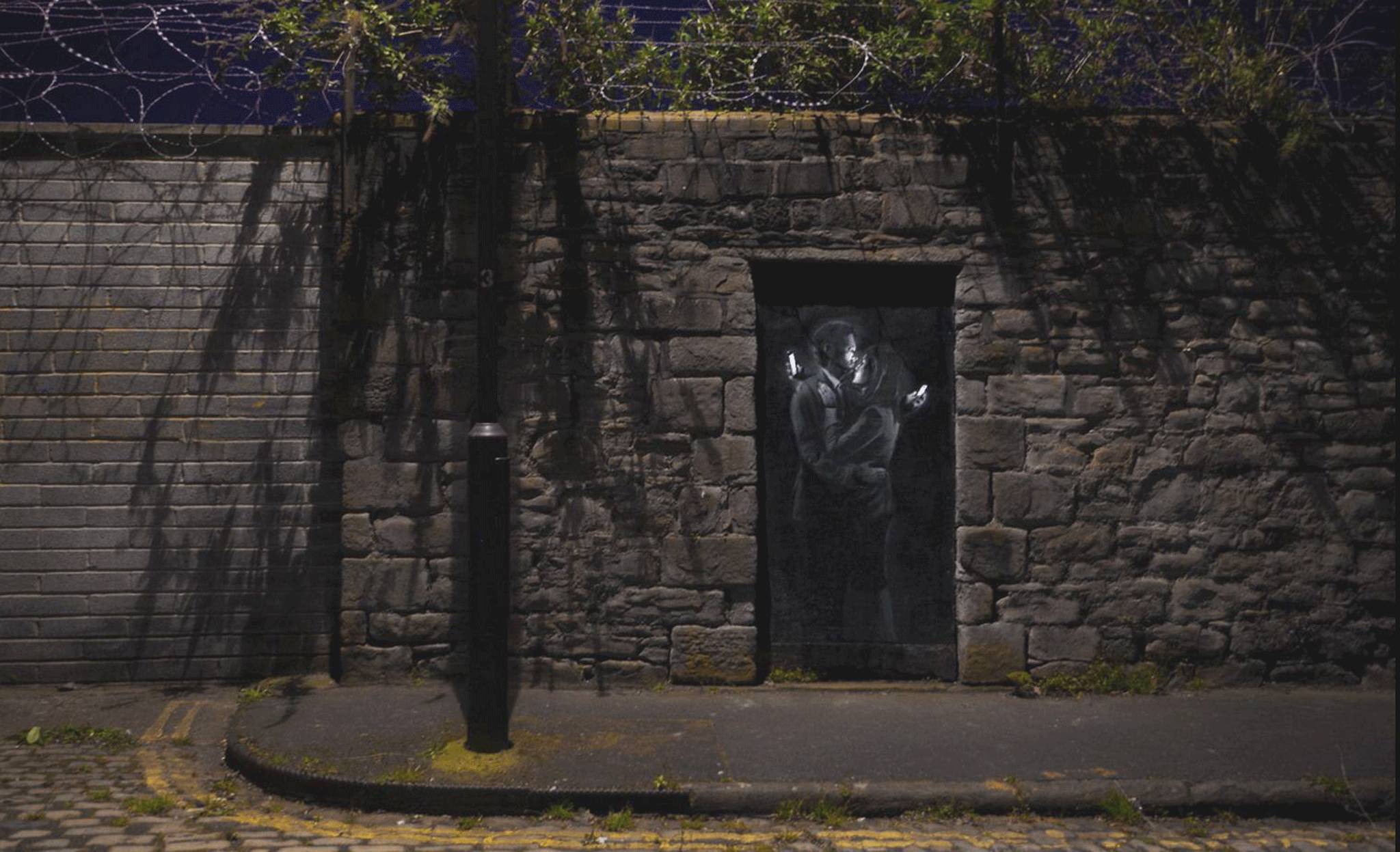 Mural is crowned by barbed wire (Picture: Banksy)