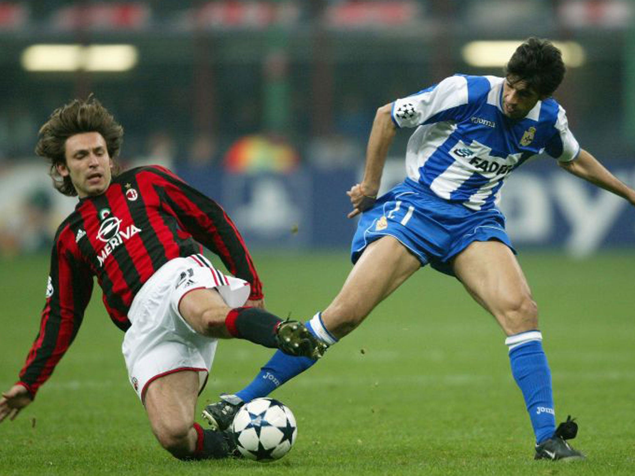 Andrea Pirlo (left), then with Milan, battles for the ball in the quarter-final against Deportivo in April 2004