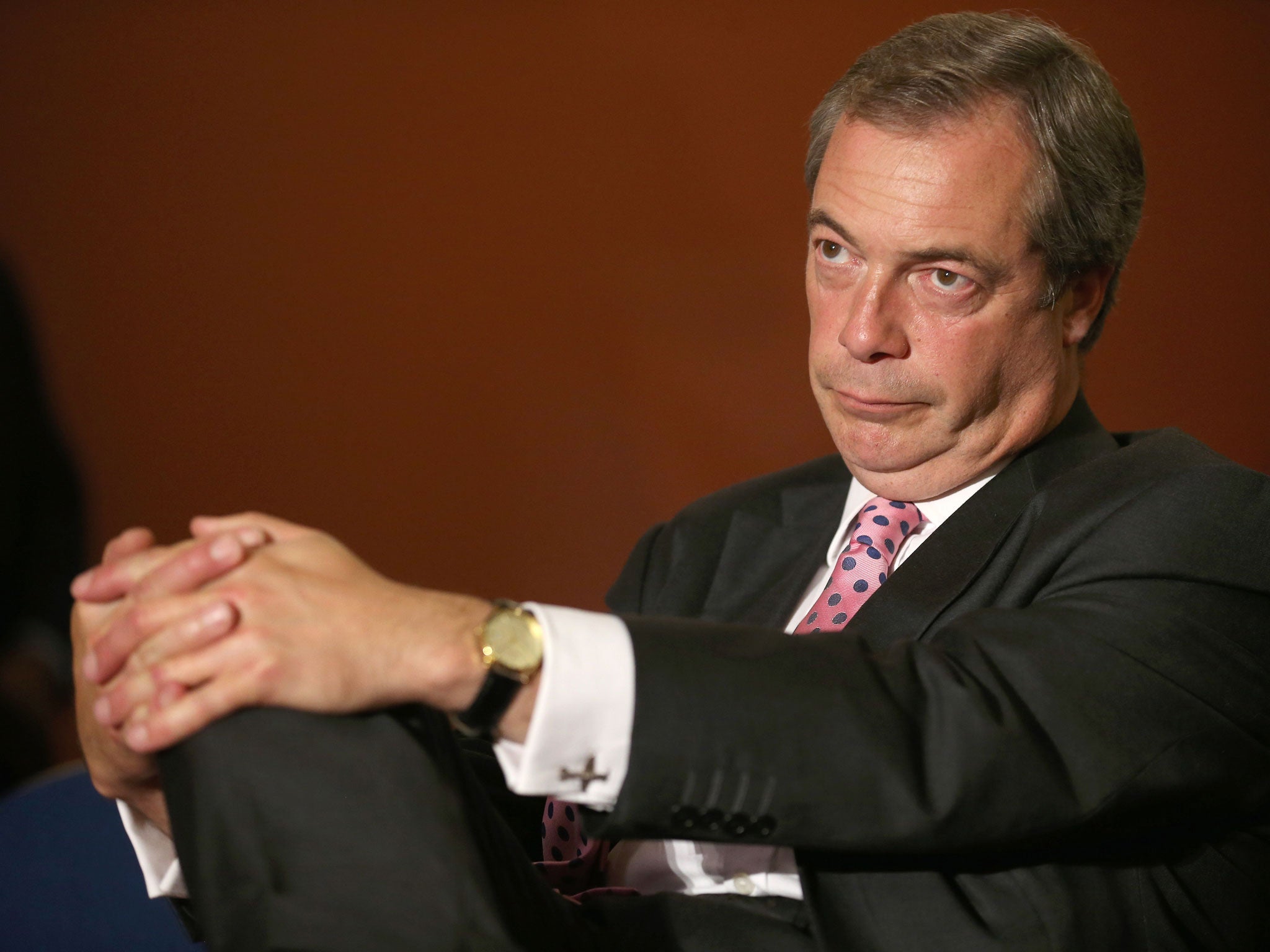 LONDON, ENGLAND - SEPTEMBER 20: Leader of UKIP Nigel Farage sits in the auditorium as he listens to a speaker during the party conference on September 20, 2013 in London, England. Members of the United Kingdom Independent Party have gathered at Central Ha