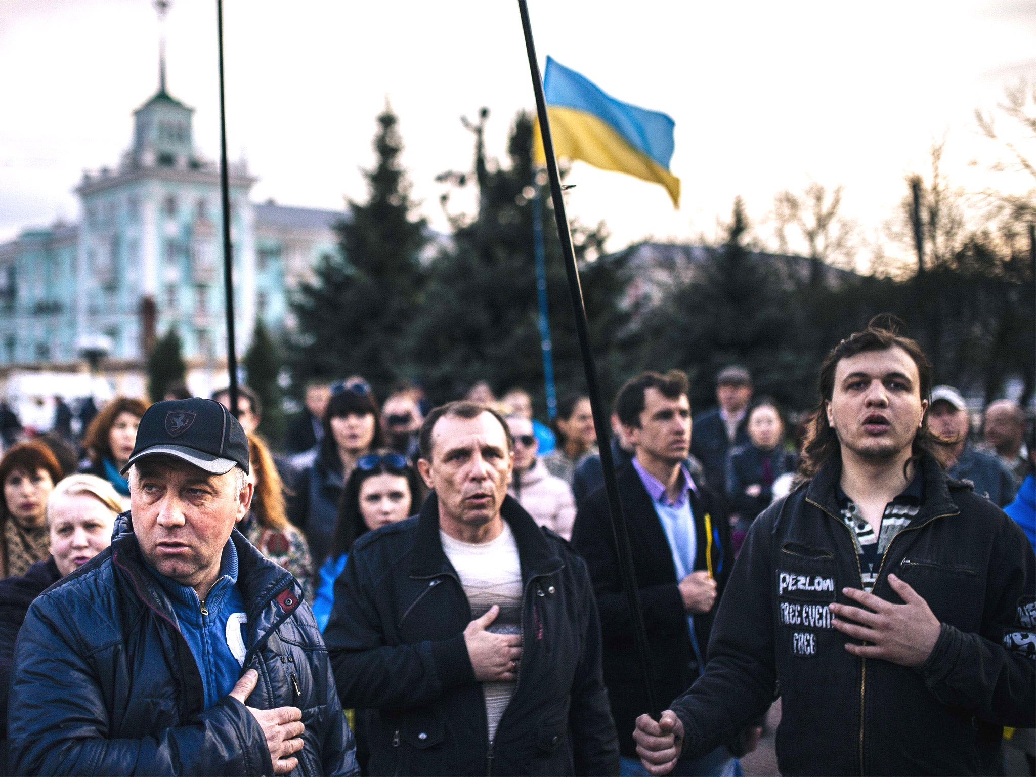 Ukrainians sing their national anthem during a pro-Kiev rally in the eastern city of Luhansk (Getty)