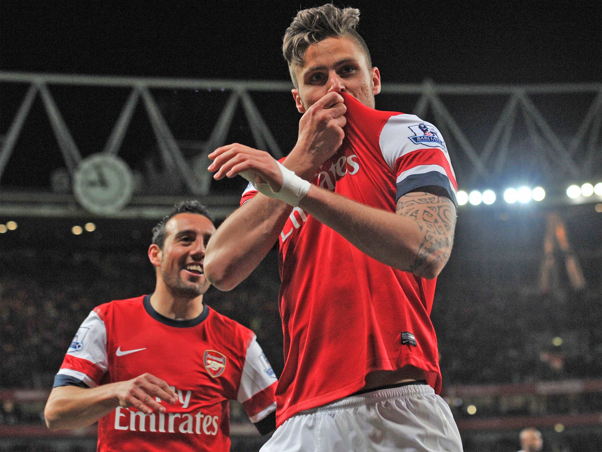 Oliver Giroud kisses the Arsenal badge after giving the Gunners the lead