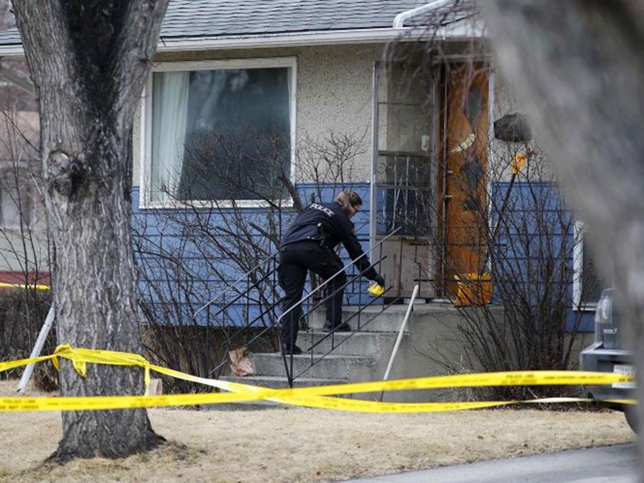 A police officer seals off the scene of the stabbing