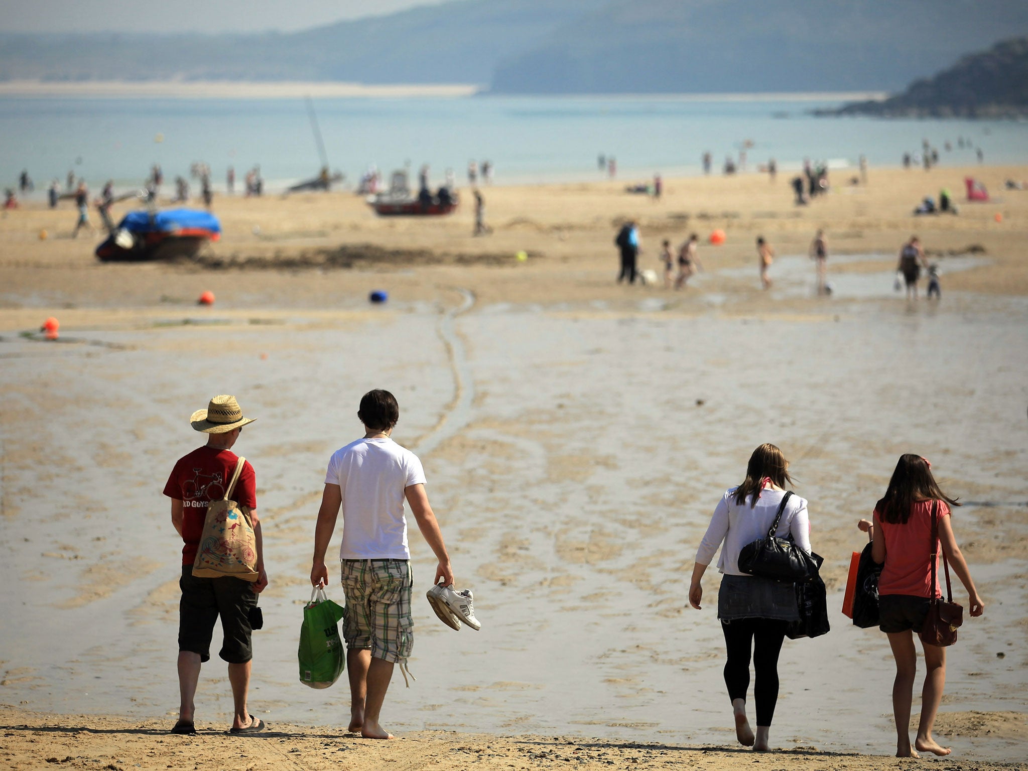 People enjoy the fine weather on April 20, 2011 in St Ives harbour, Cornwall, England.