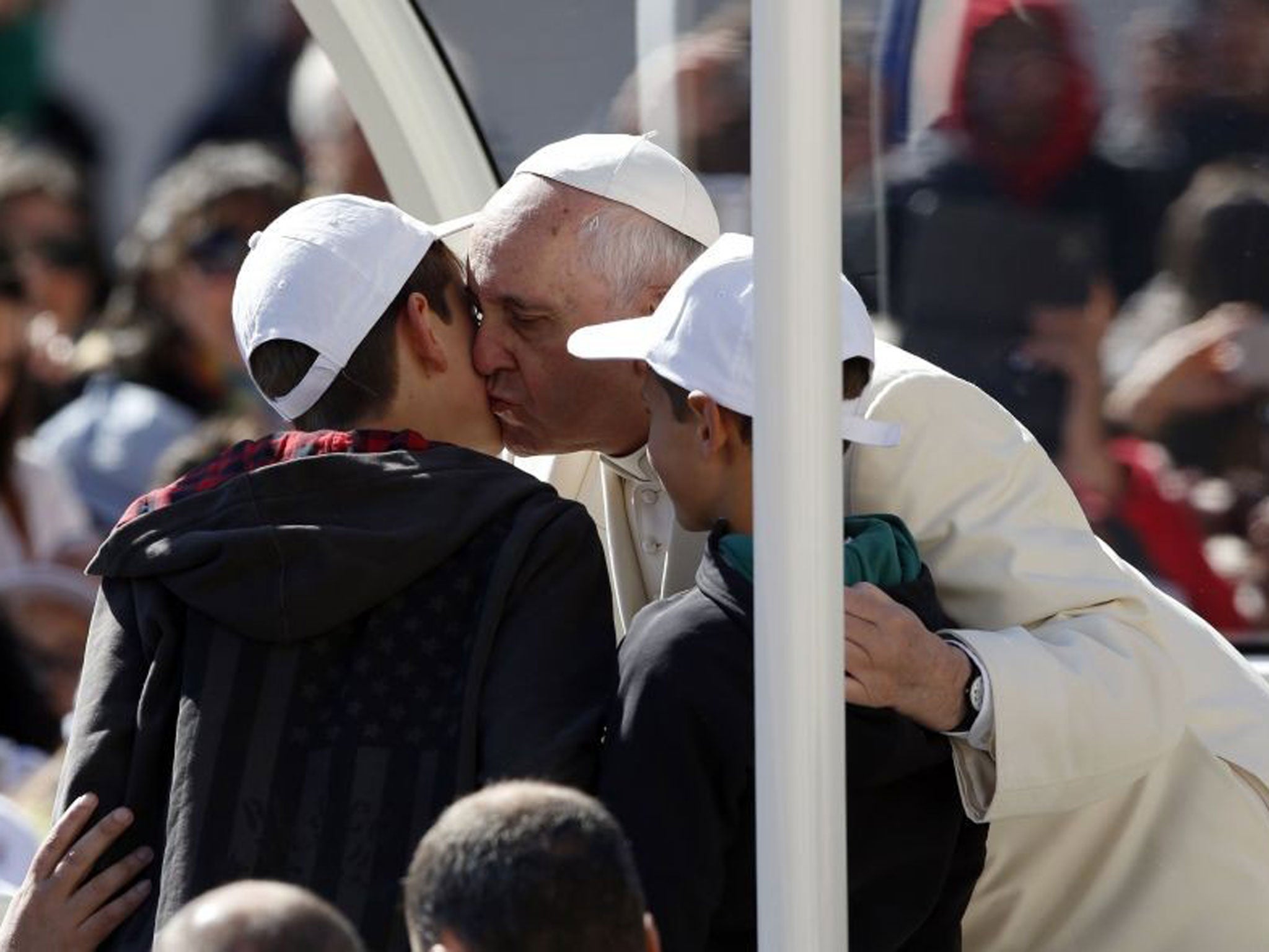 Pope Francis welcomes the Perugian boys onto his Popemobile with a kiss