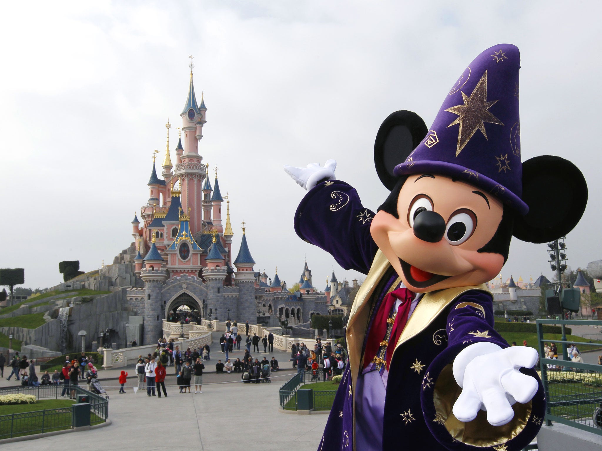 Disney character Mickey poses in front of the Sleeping Beauty Castle at Disneyland park as part of the 20th birthday celebrations of the park, in Chessy, near Marne-la-Vallee, outside Paris, on March 31, 2012.