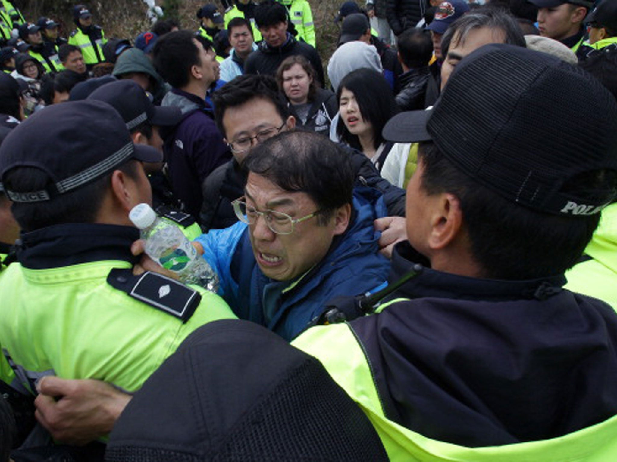 Frustrated family members attempt to break through police lines