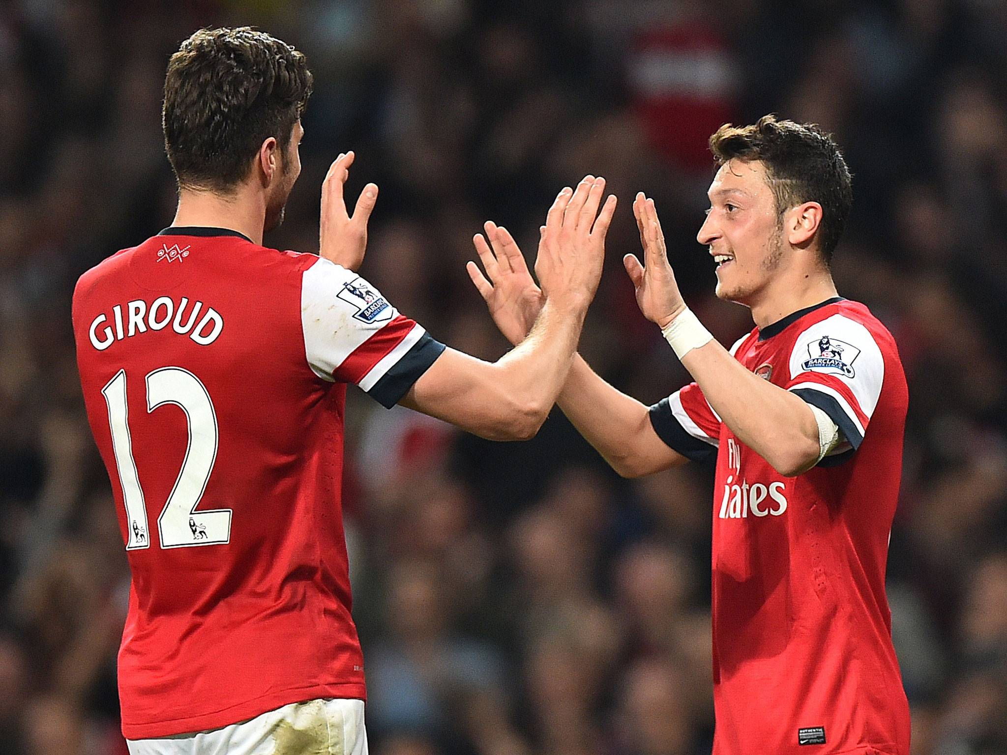 German midfielder Mesut Ozil, right, celebrates with Frenchman Olivier Giroud after scoring the second goal of the night