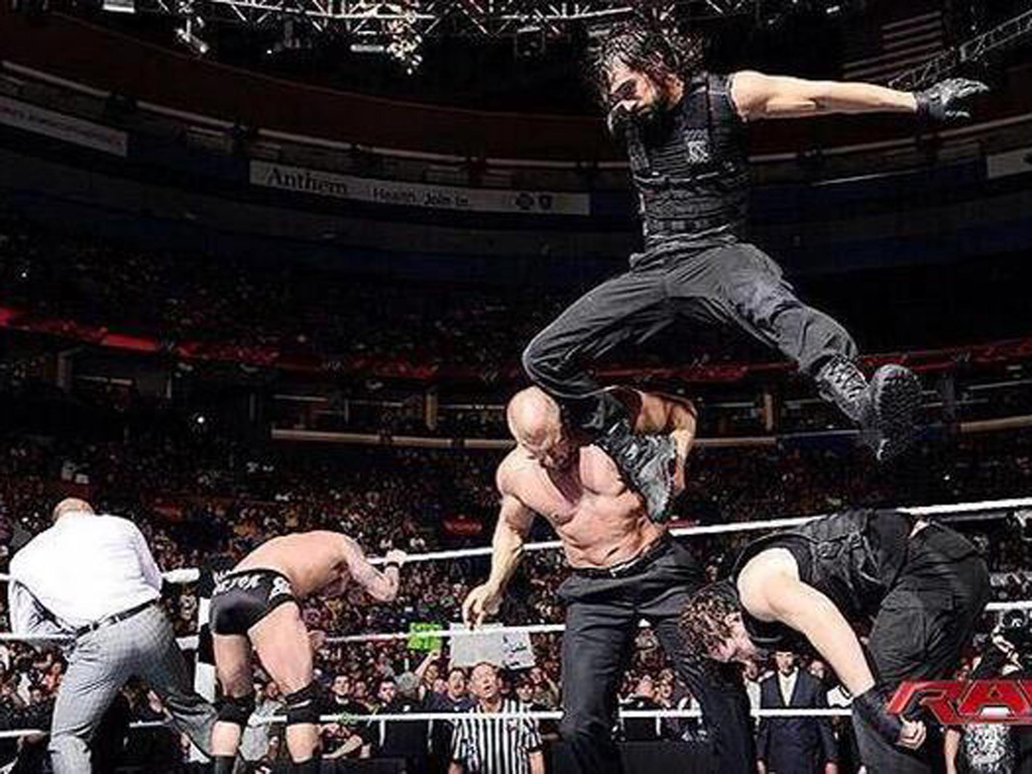 Seth Rollins of The Shield hits Triple H with a knee to the head