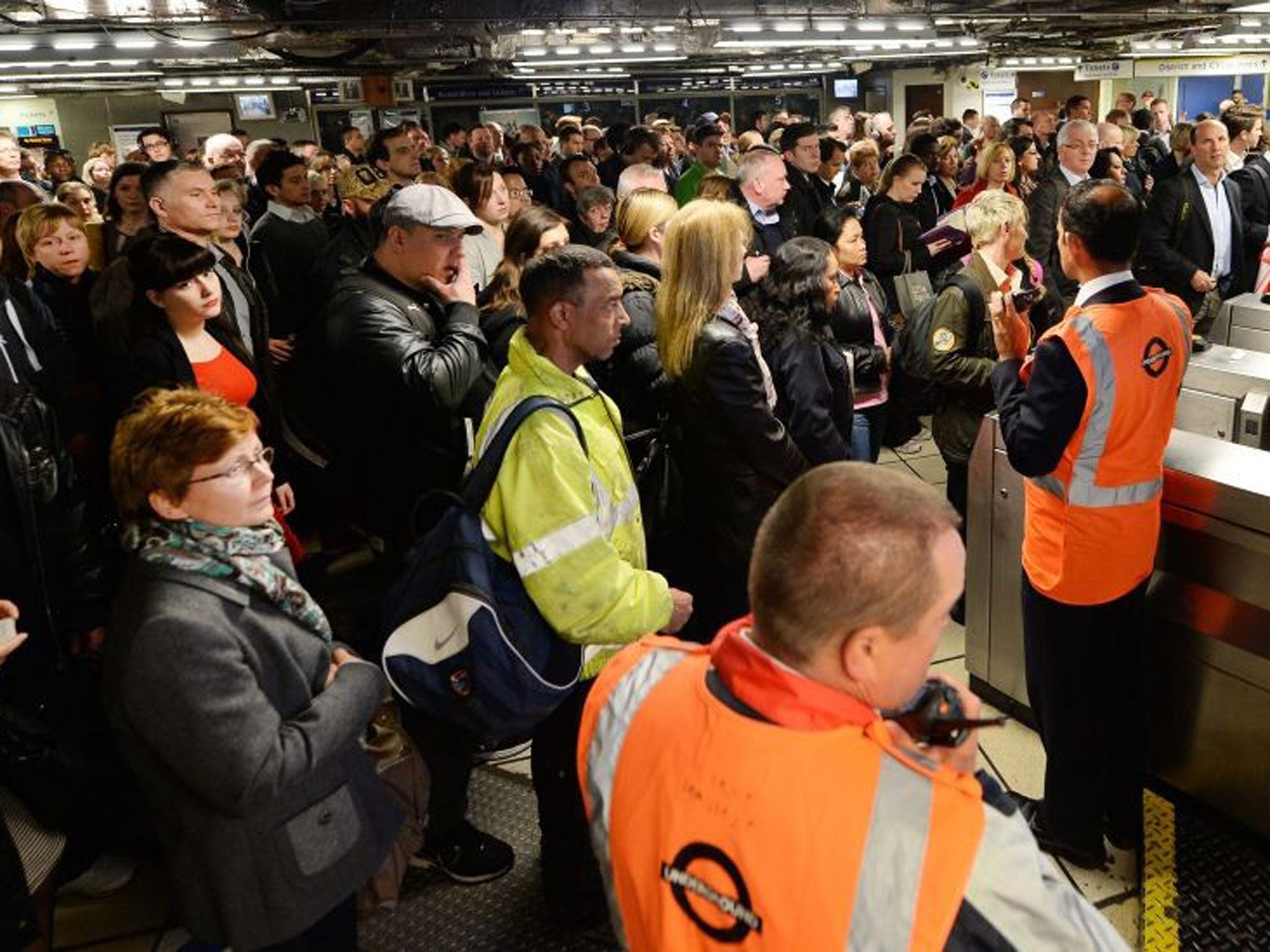 Commuters wait at Victoria tube station for limited service trains in London, Britain, 29 April 2014.