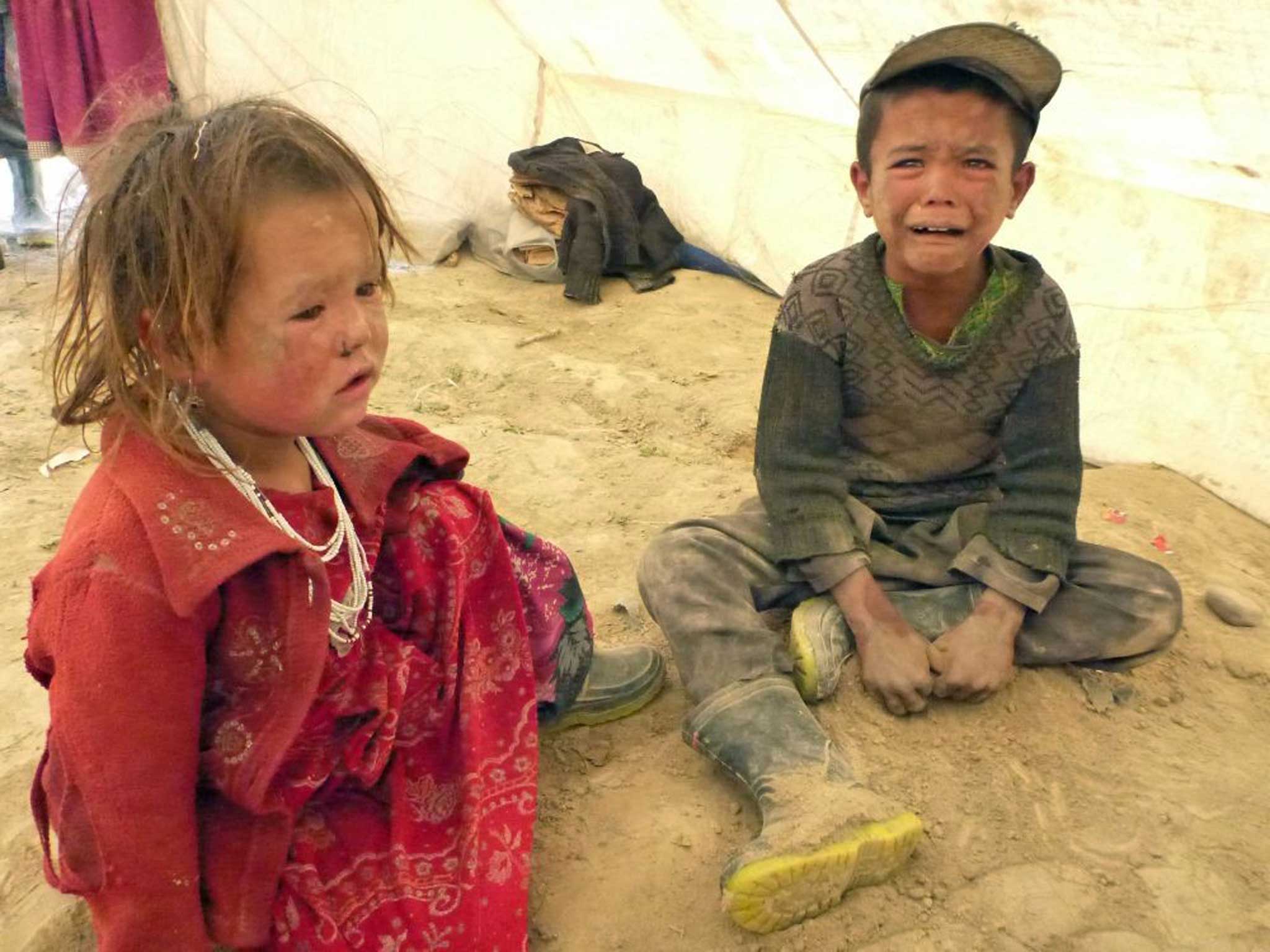 Afghan children cry after being rescued - an estimated 300 families were affected