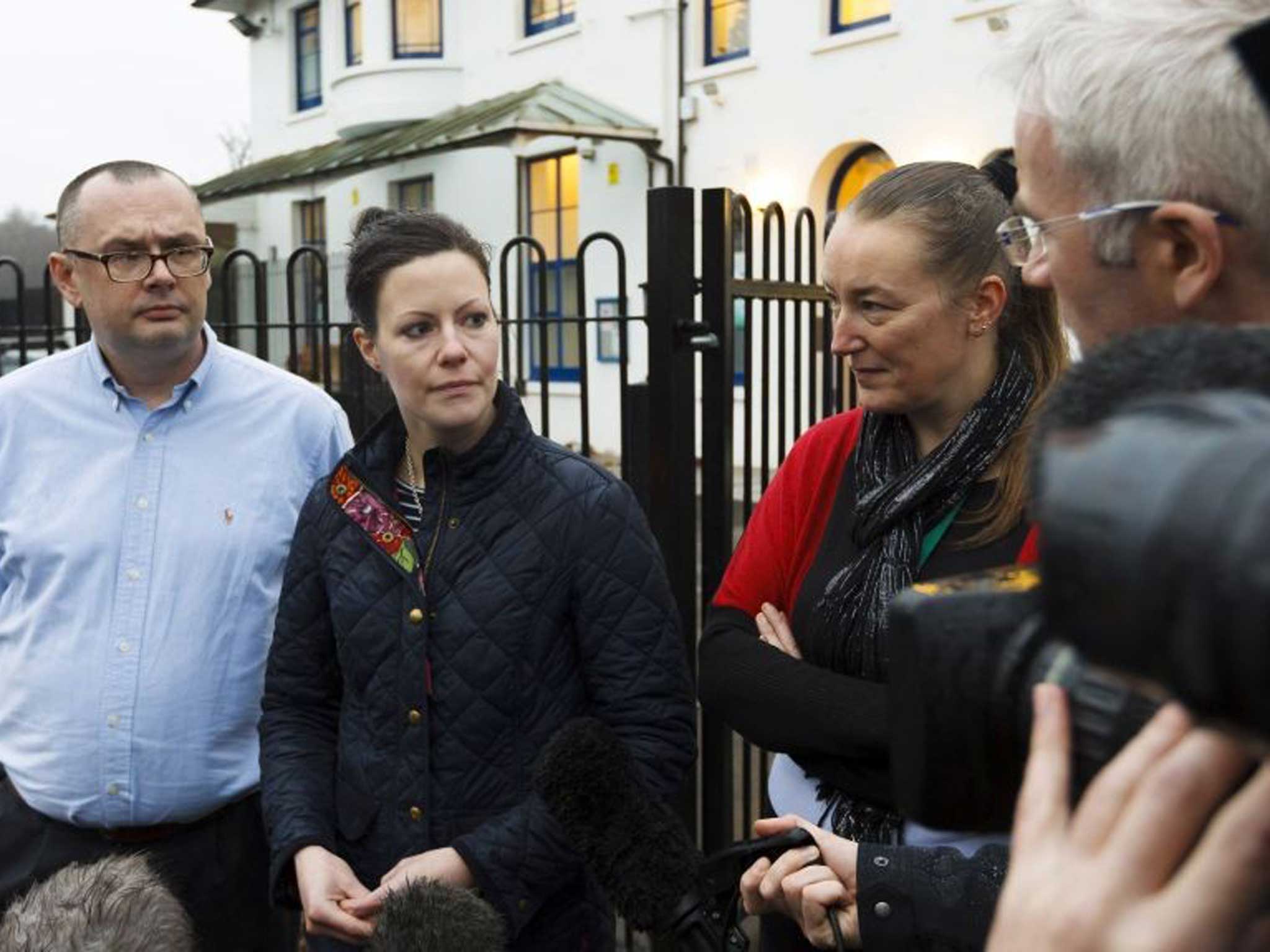 Emily Leppenwell (second left), one of the parents at the school, makes a statement on behalf of Discovery New School