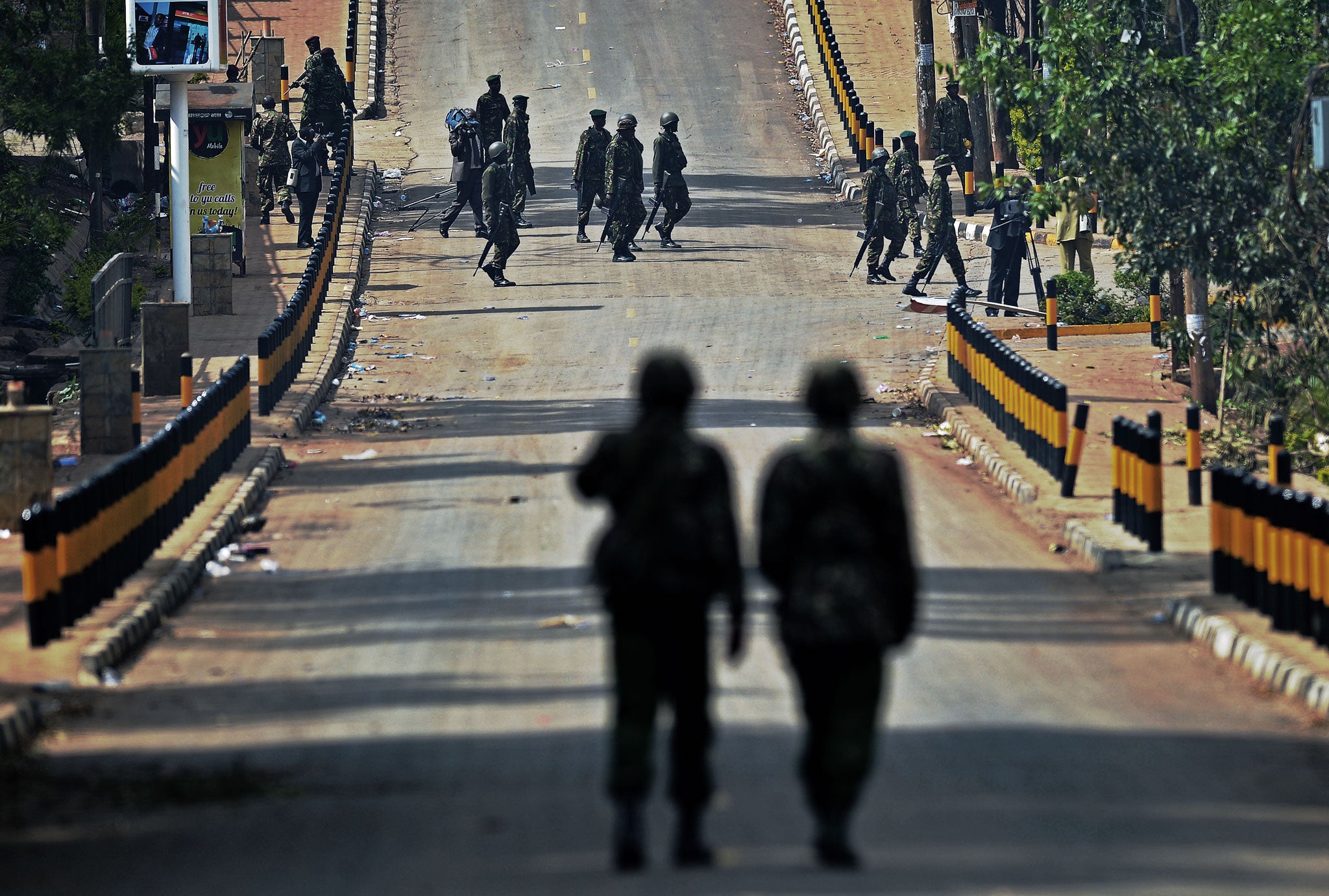 Kenyan soldiers walk on the road outside the Westgate shopping mall in Nairobi, which was attacked by al Shabaab militants last September, leaving 67 people dead. Kenya has blamed the al-Qa’ida-linked Somali group for a string of further attacks in the co