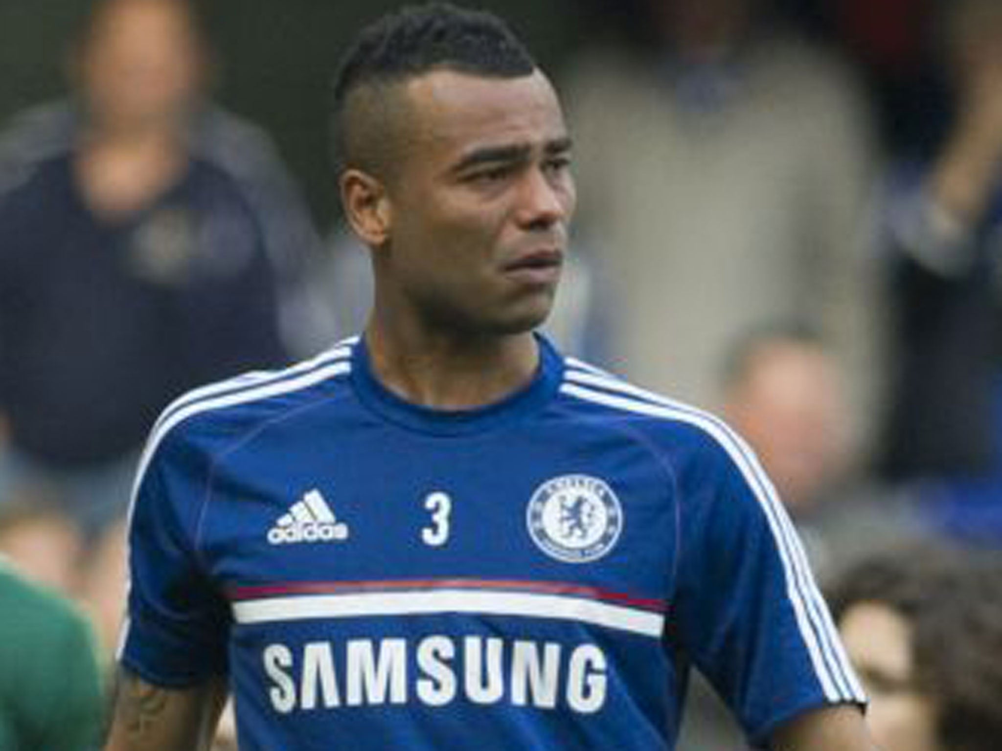 Ashley Cole looks devastated as he walks around the Stamford Bridge pitch after the match on Sunday