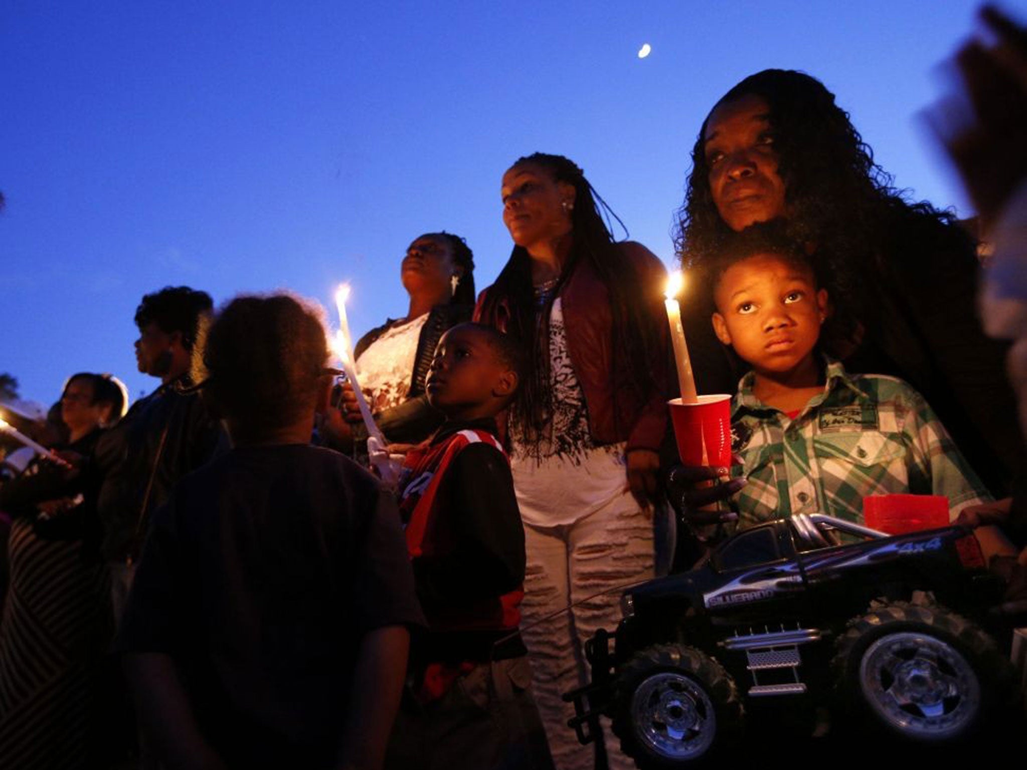 Diamonte Scott, 6, stands with his grandmother Irene Giles during a prayer vigil for Martin Cobb, the 8 year-old who was killed trying to defend his 12 year-old sister against a sexual assault. Cobb liked big-wheel trucks, so Scott brought his own with a