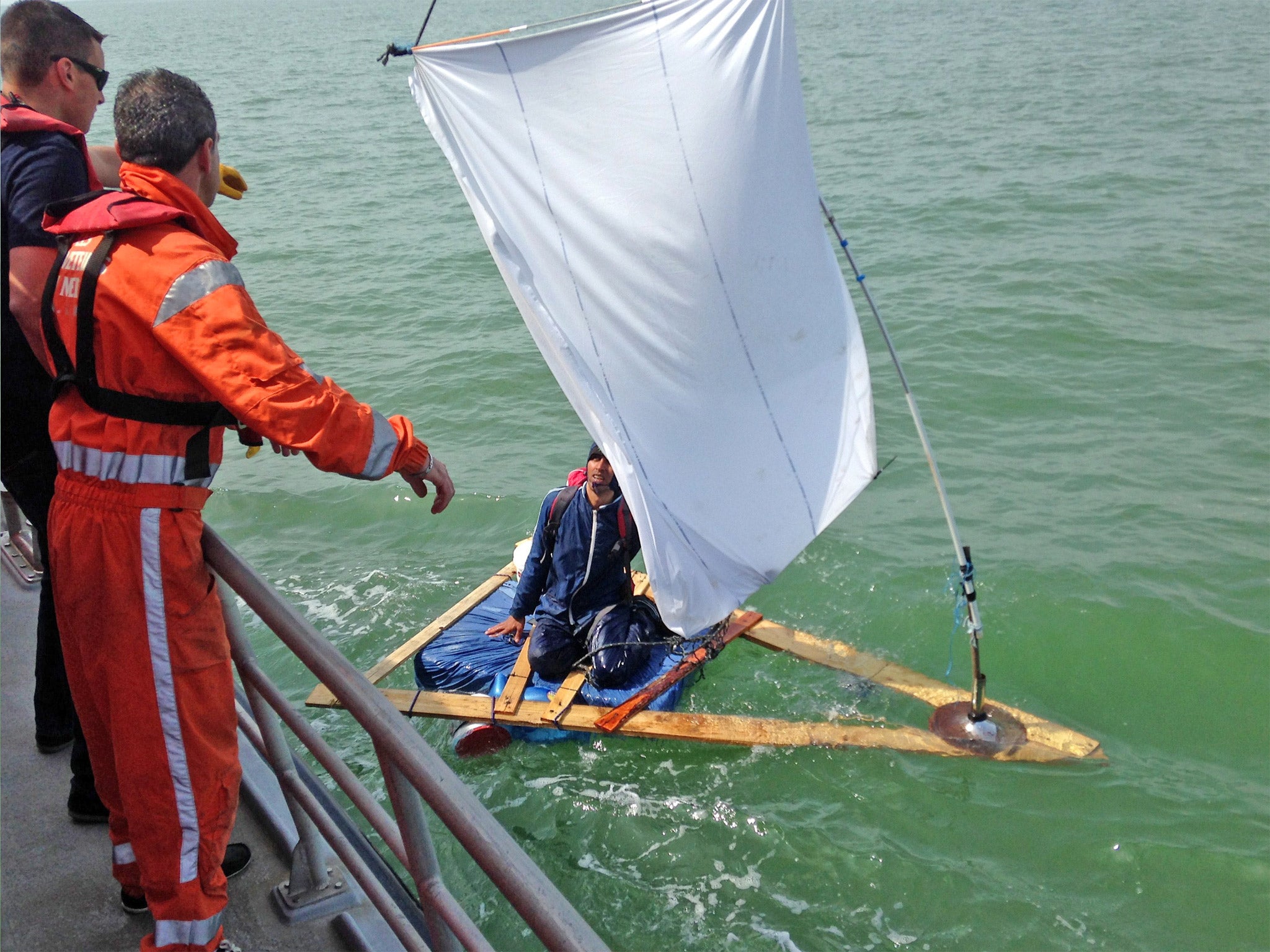 The French coastguard coming to the rescue of the Afghan aboard his home-made raft near Calais