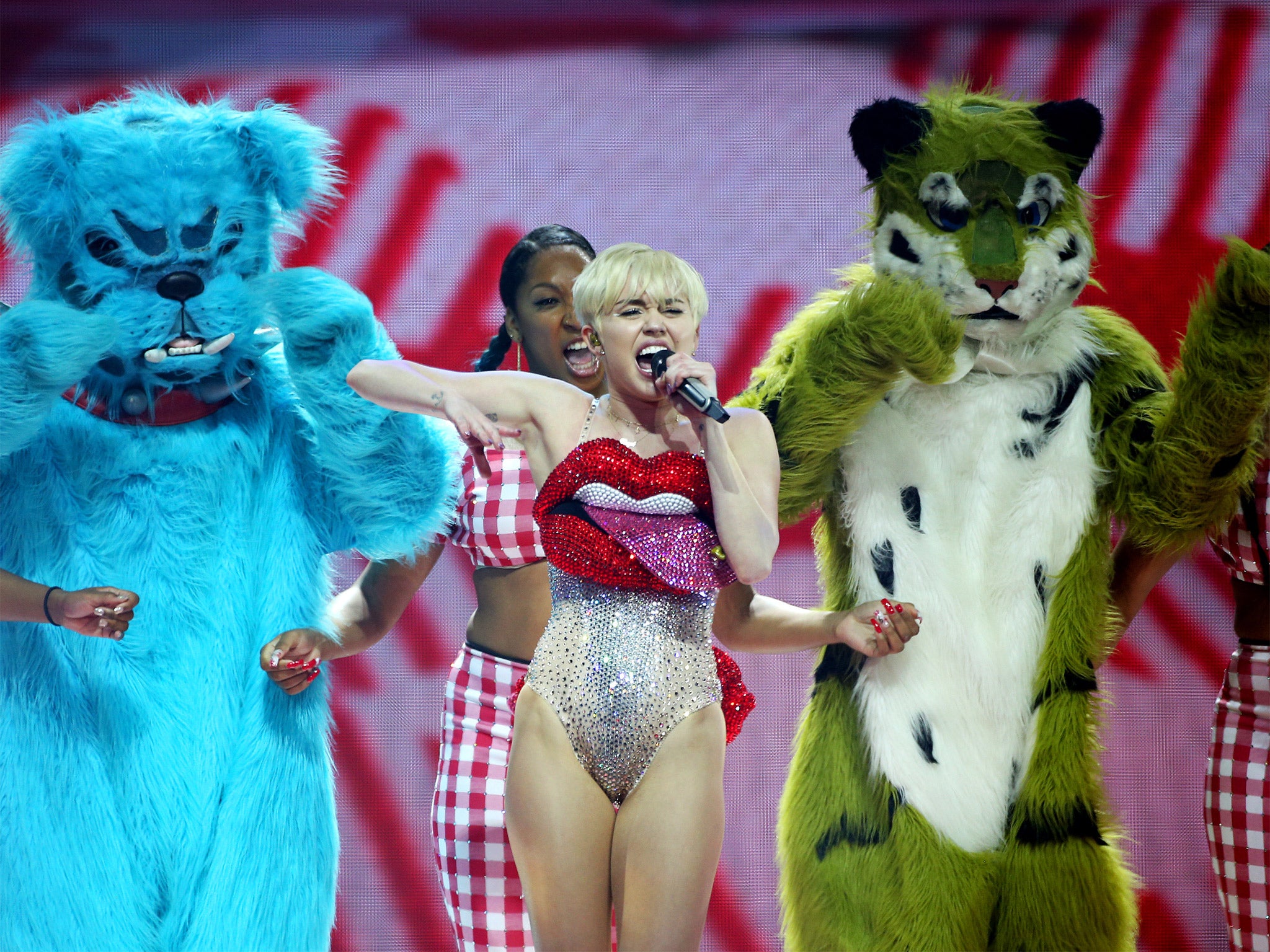 Miley and her furry friends during the pop star's lascivious show (Getty)