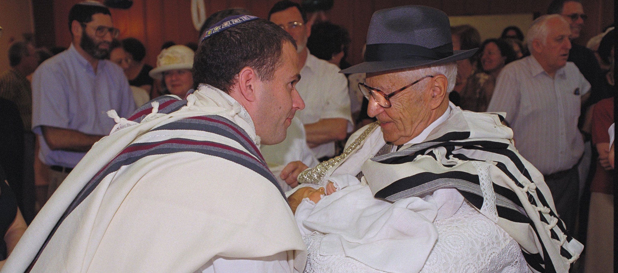 A father, son and great grandfather at a circumcision ceremony